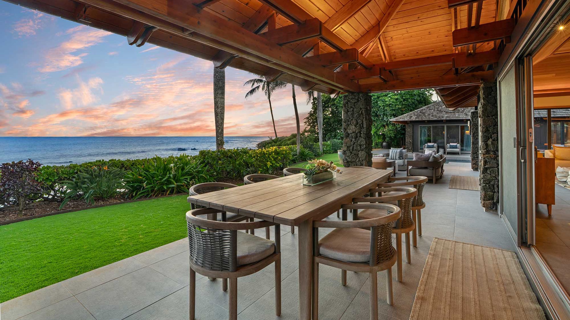 Dine with breathtaking ocean views as your backdrop, where tropical elegance meets seaside serenity on this stunning covered terrace.