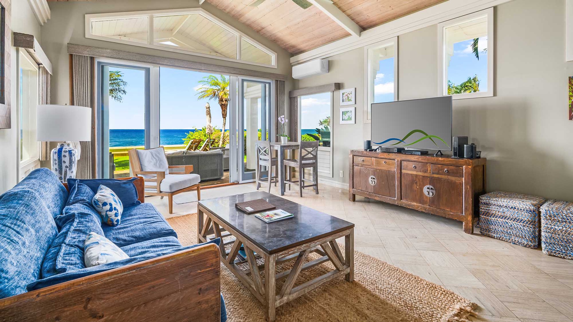 Relax in your bright, coastal-chic living space with vaulted ceilings, tropical décor, and sweeping ocean views that invite the island breeze right to your door.