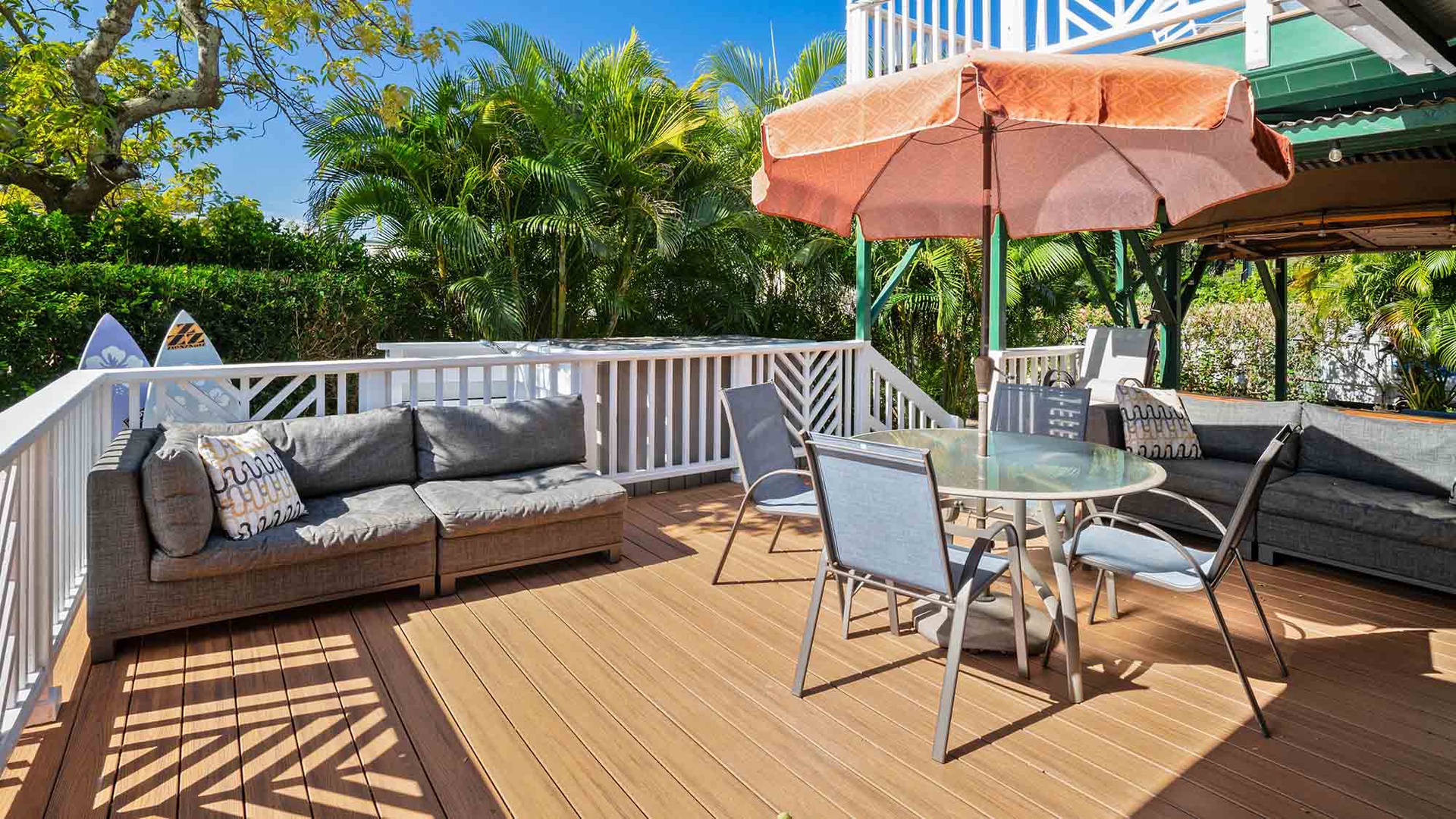 Unwind on your private deck with comfy outdoor seating, dining space, and tropical garden views—perfect for morning coffee or sunset drinks.