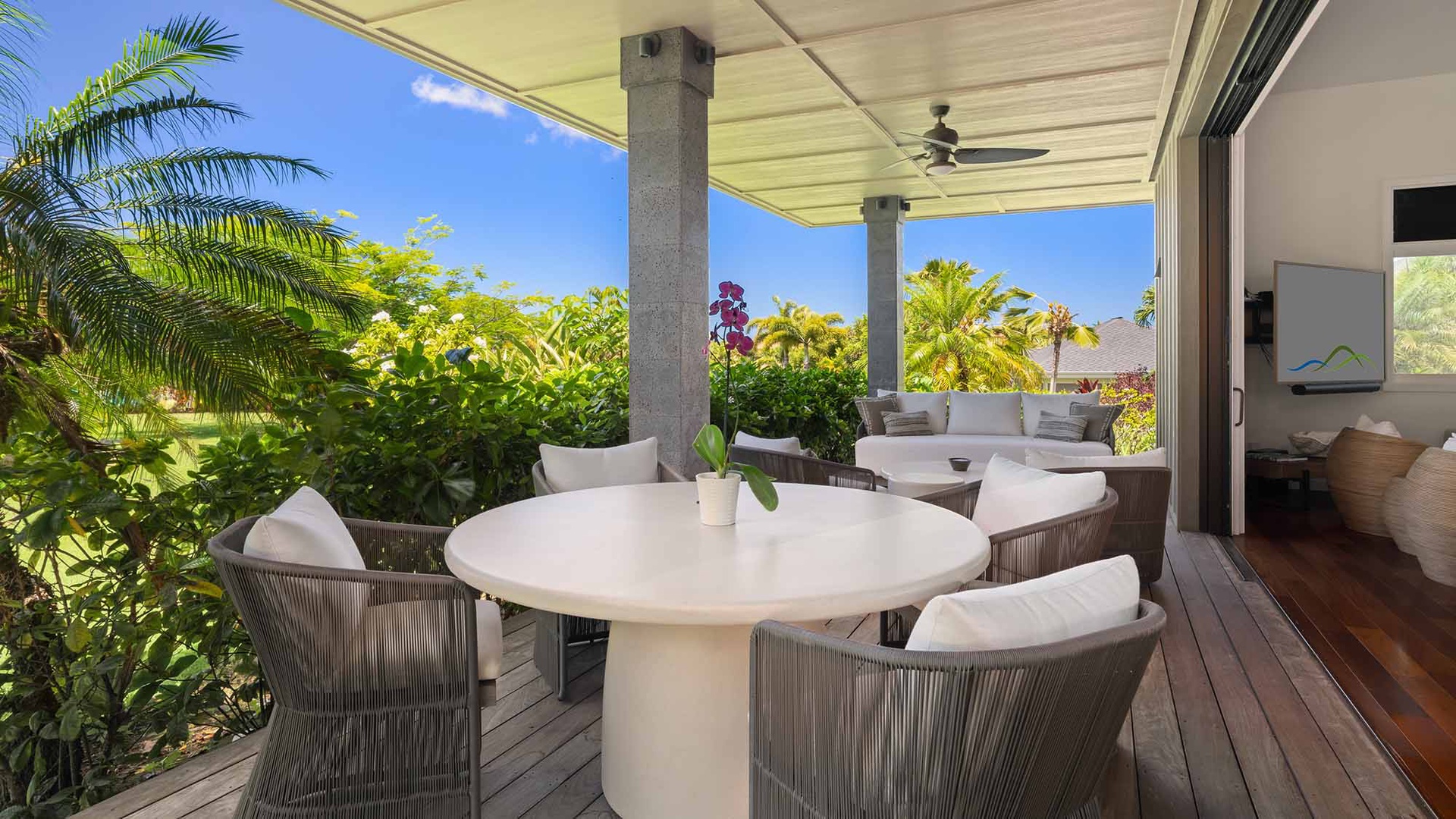 Relax on your private covered terrace, where tropical breezes meet stylish comfort. Enjoy morning coffee at the elegant dining table, surrounded by lush greenery and peaceful garden views.
