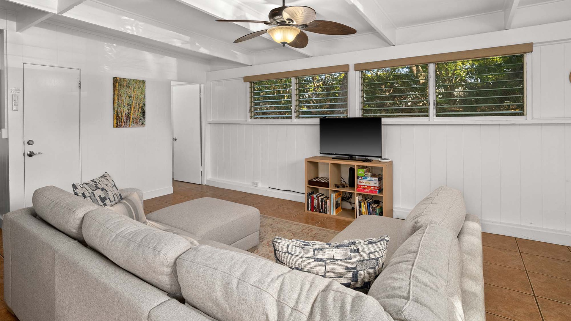 Unwind in your bright living space with plush sectional seating, ceiling fan comfort, and entertainment ready for cozy evenings together.