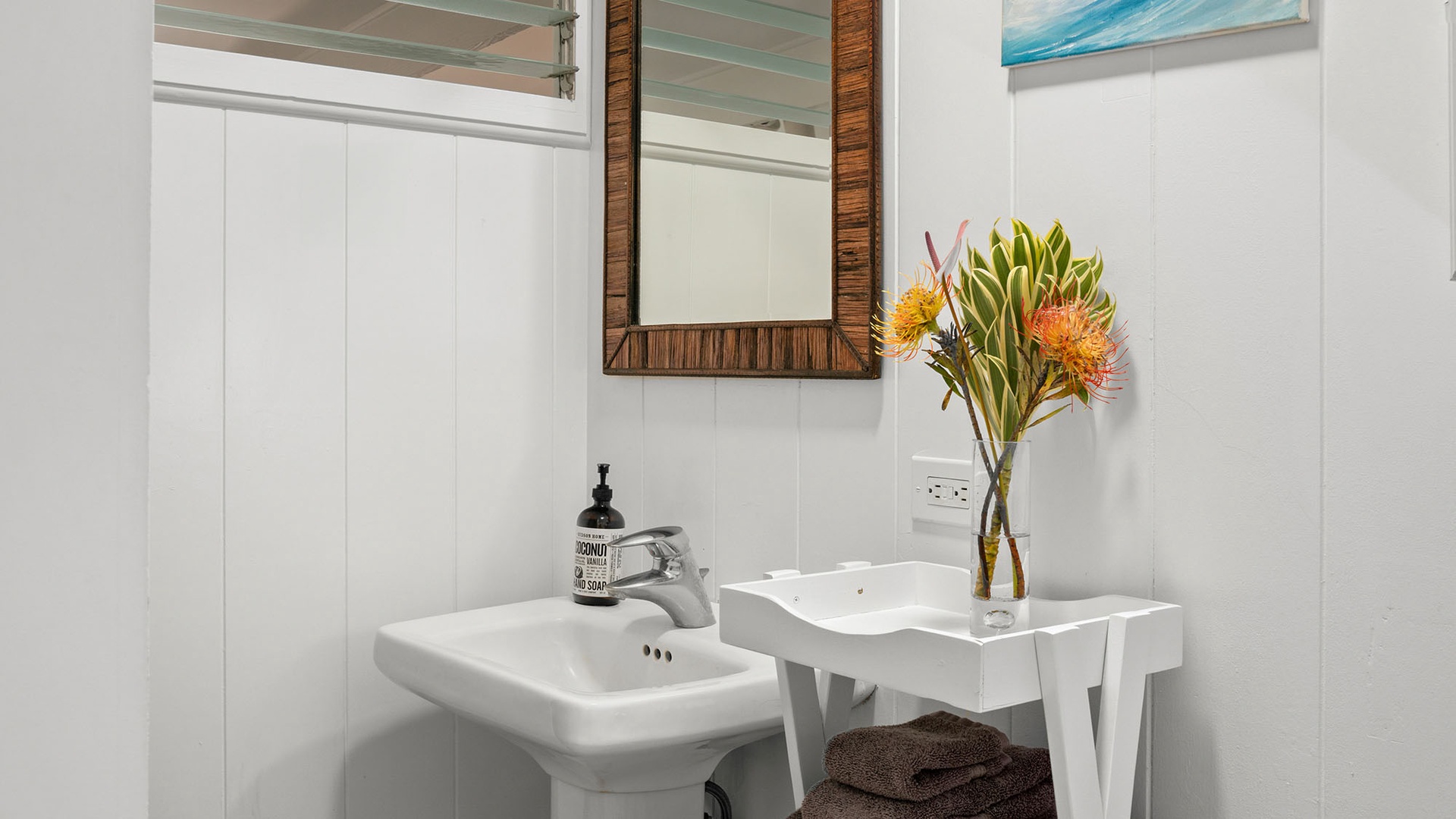 Fresh flowers brighten your modern bathroom's sleek white vanity, creating a spa-like retreat with contemporary fixtures and thoughtful touches.