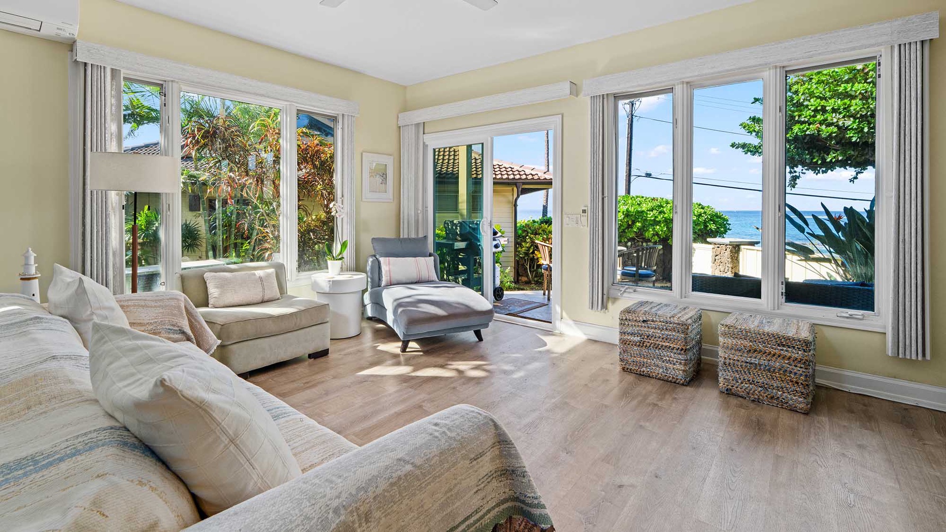 Sink into plush seating while soaking up stunning ocean views through floor-to-ceiling windows that frame your perfect coastal escape.