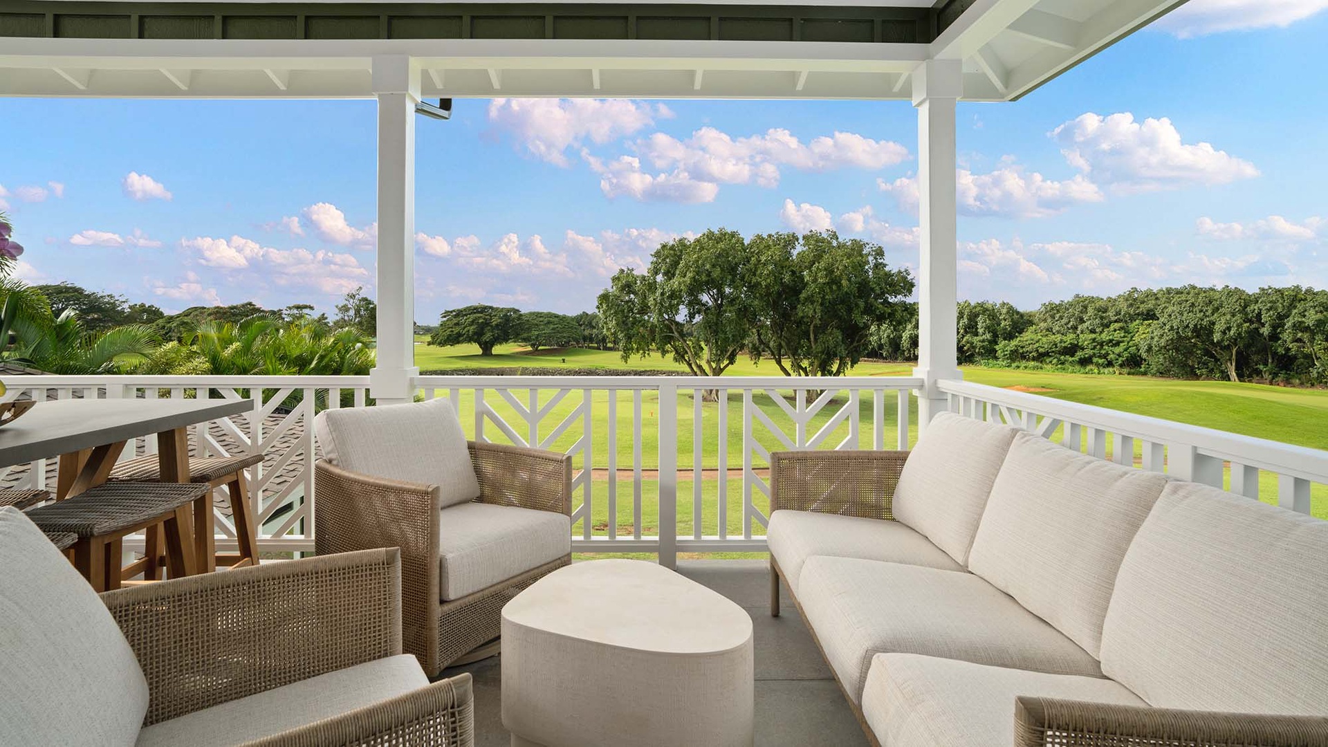 Unwind on your private terrace with plush seating as you soak in stunning golf course views beneath blue skies.
