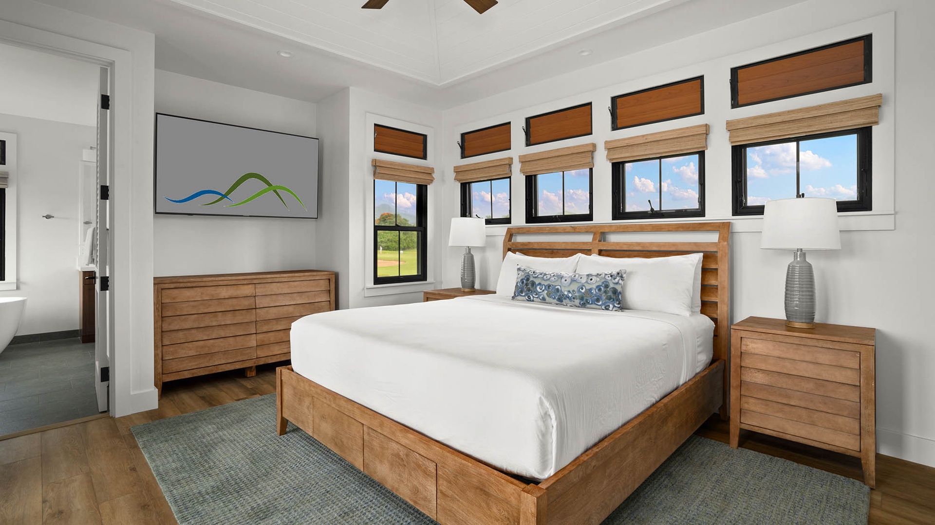 Unwind in your serene bedroom with crisp linens, warm wood accents, and peaceful views that invite restful nights.
