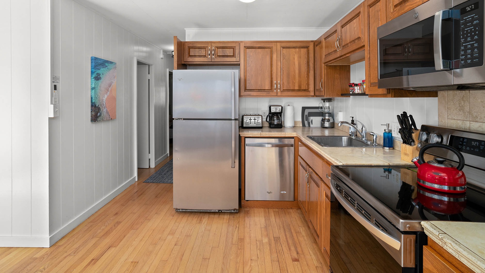 Your fully equipped kitchen awaits with stainless steel appliances, warm wood cabinetry, and everything needed to create memorable meals during your stay.