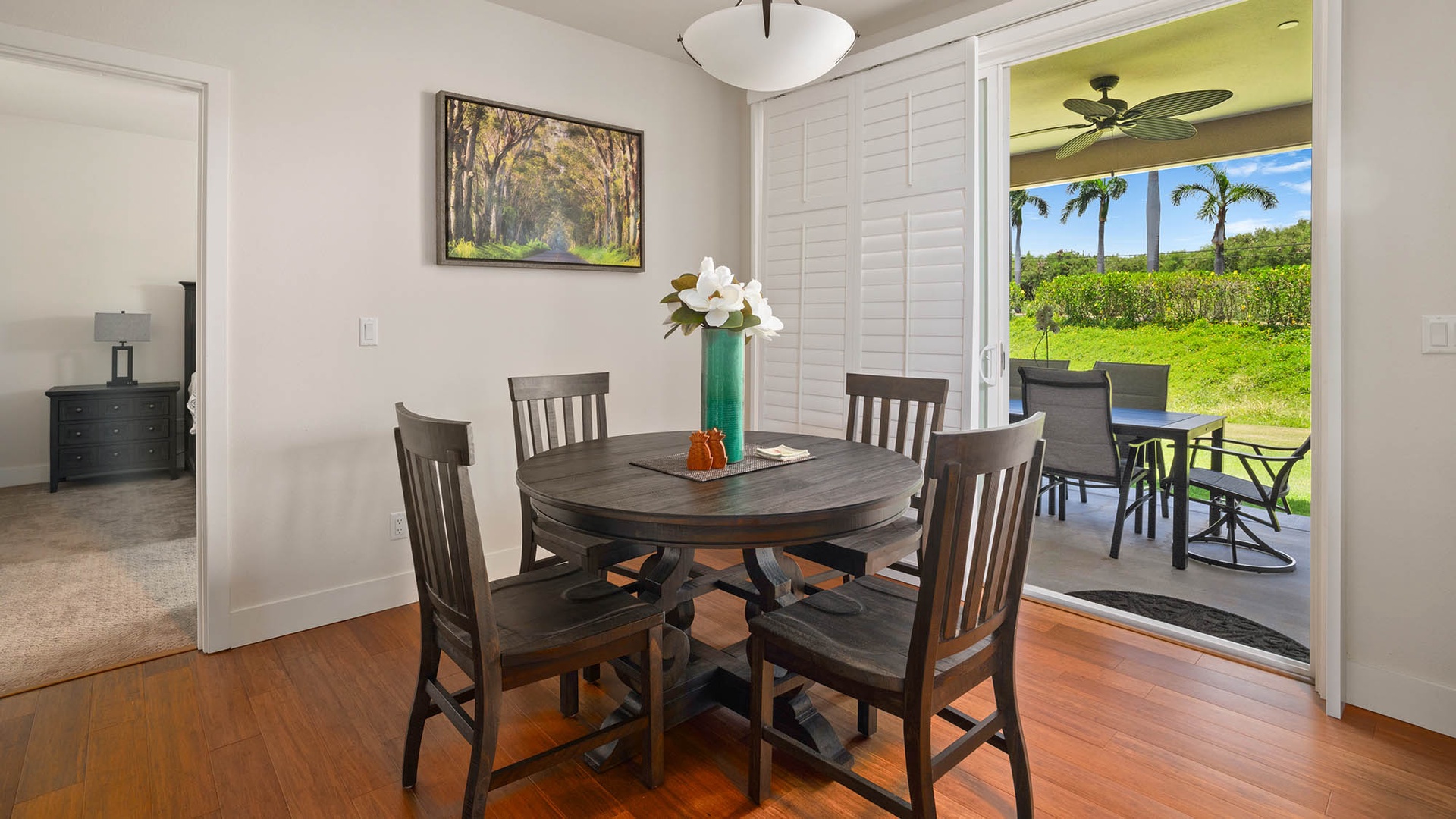 Gather around the table for meals with tropical garden views just beyond the patio doors, where palm trees frame your peaceful island escape.
