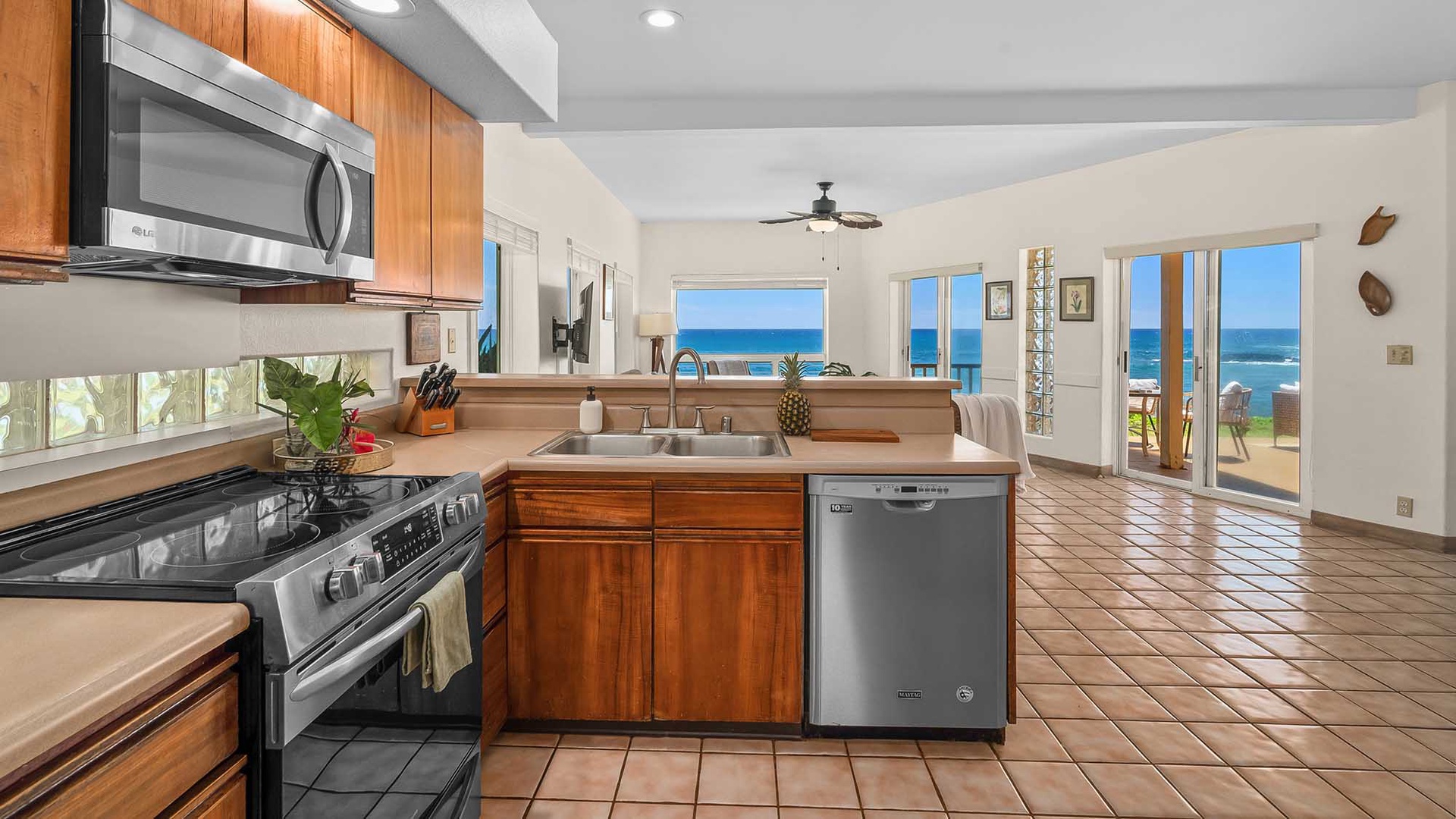 Bright and open with warm wood cabinetry, this kitchen flows into a living space framed by stunning ocean views—you'll love cooking with the sea right before your eyes.