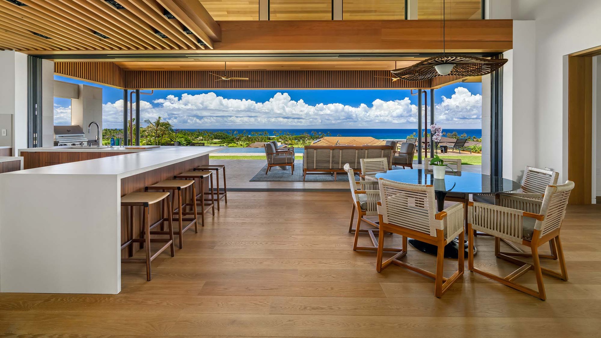 Enjoy your morning coffee at the spacious island, gather for meals at the elegant dining table, or step outside to take in breathtaking ocean views—all within this stunning open-concept living space.