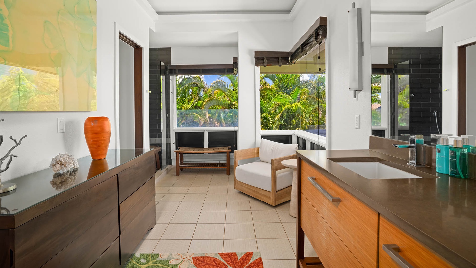 Step into your modern ensuite where vibrant tropical views and sleek design create a spa-like escape. Unwind in comfort with art, lush greenery, and thoughtful touches at every turn.