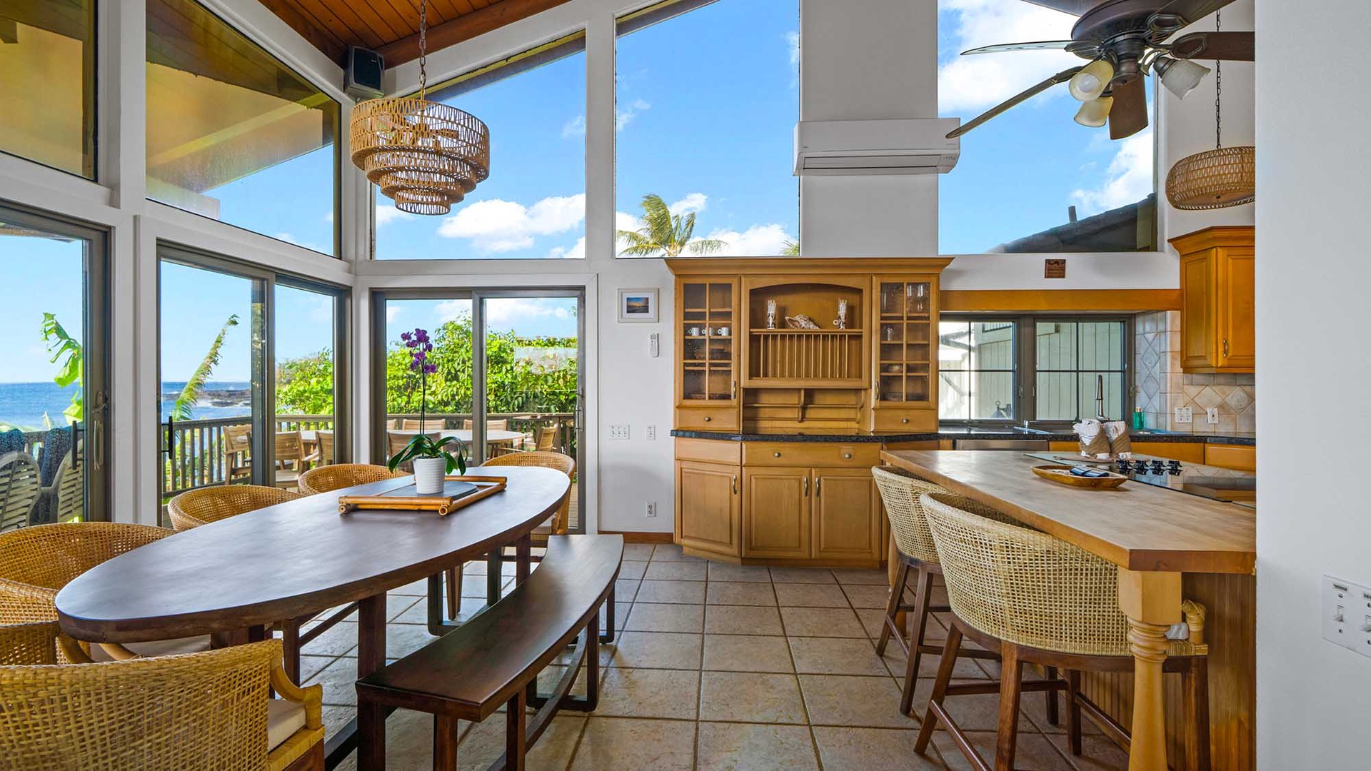 Your gourmet kitchen flows seamlessly into the dining area, where ocean breezes drift through floor-to-ceiling windows as you prepare meals with stunning sea views.