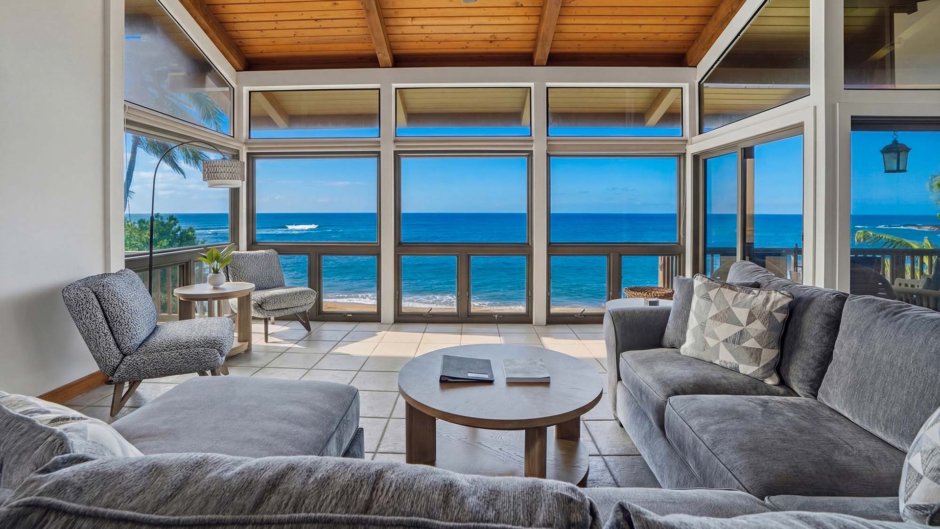 Sink into plush seating while panoramic ocean views fill every window, creating your perfect beachfront sanctuary.