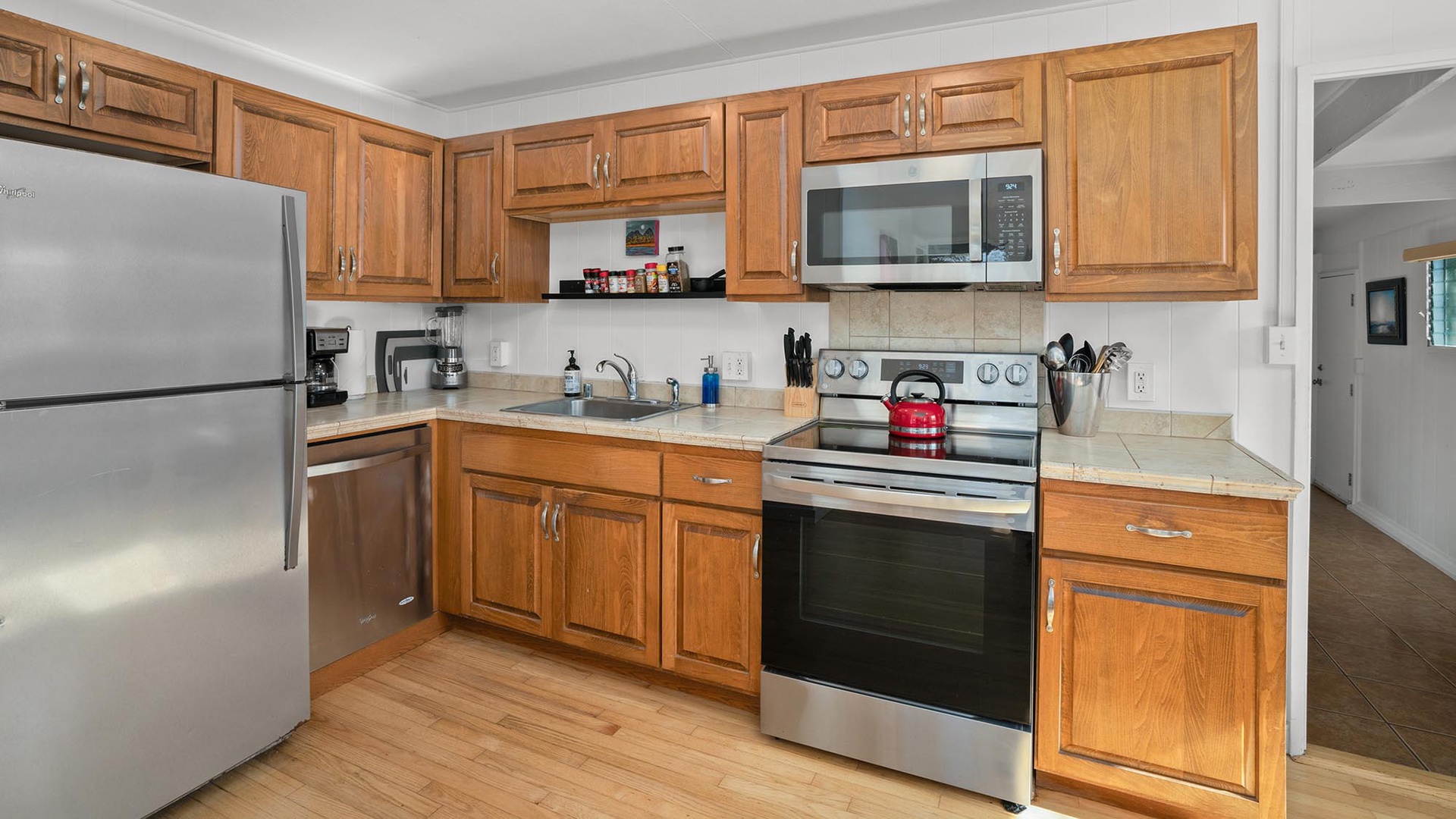 Cook your favorite meals in this fully-equipped kitchen featuring stainless steel appliances and warm wood cabinets.