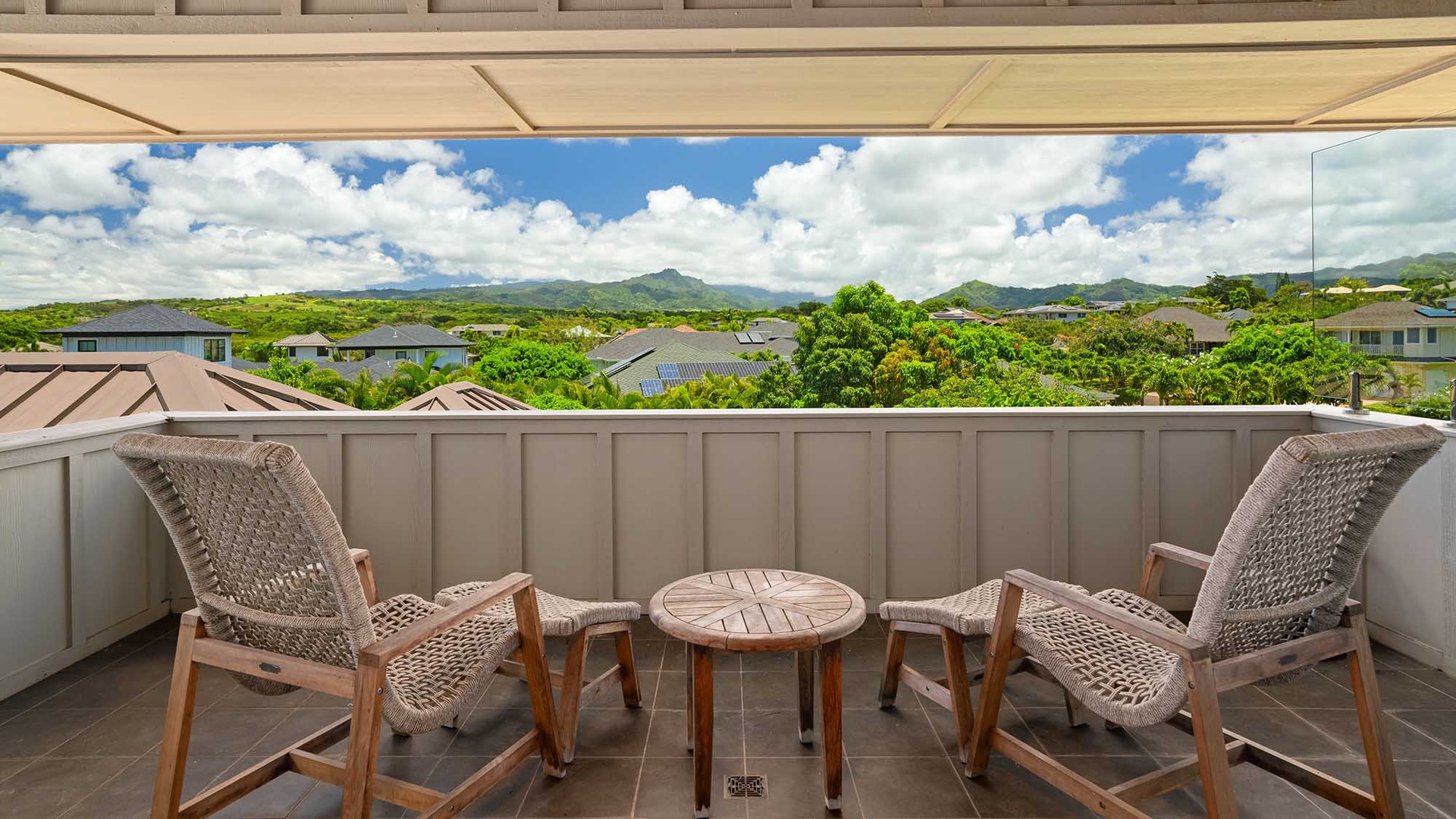 Scenic mountain views and lush greenery frame this peaceful outdoor terrace. Relax under the shade and let the vibrant landscape inspire your island getaway.