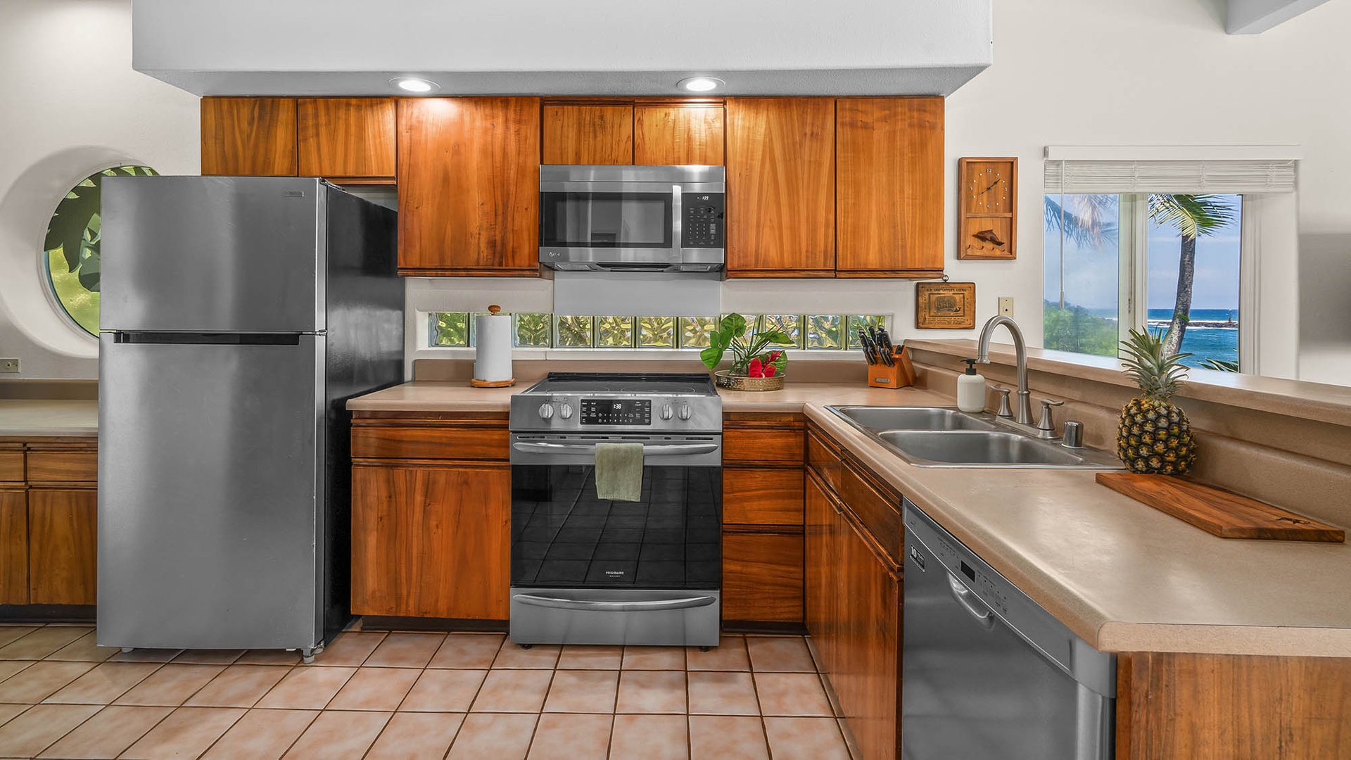 Your fully equipped kitchen invites you to prepare island-inspired meals with stunning ocean views just beyond the window, blending tropical elegance with modern convenience.