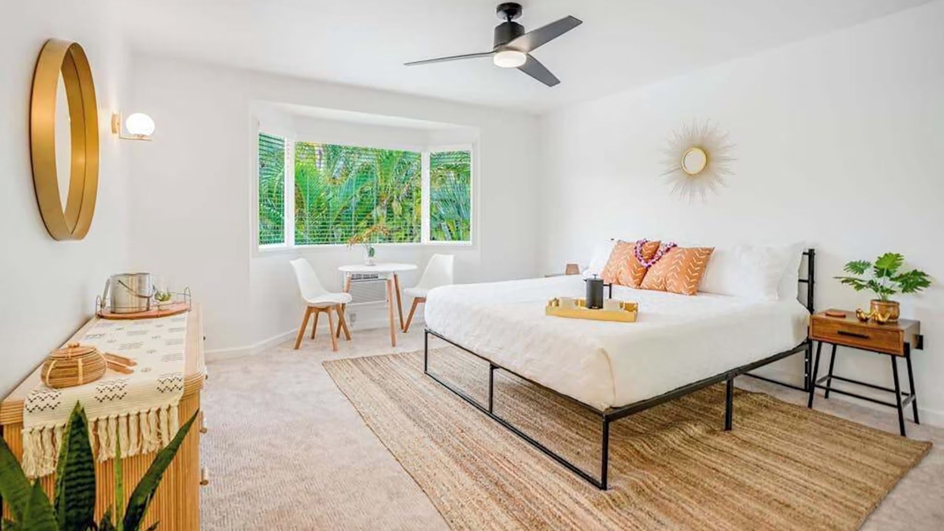 Slip into crisp, hotel-quality linens and wake up to lush tropical greenery framed by bright windows. Your private retreat features mid-century touches and a ceiling fan to keep you cool.
