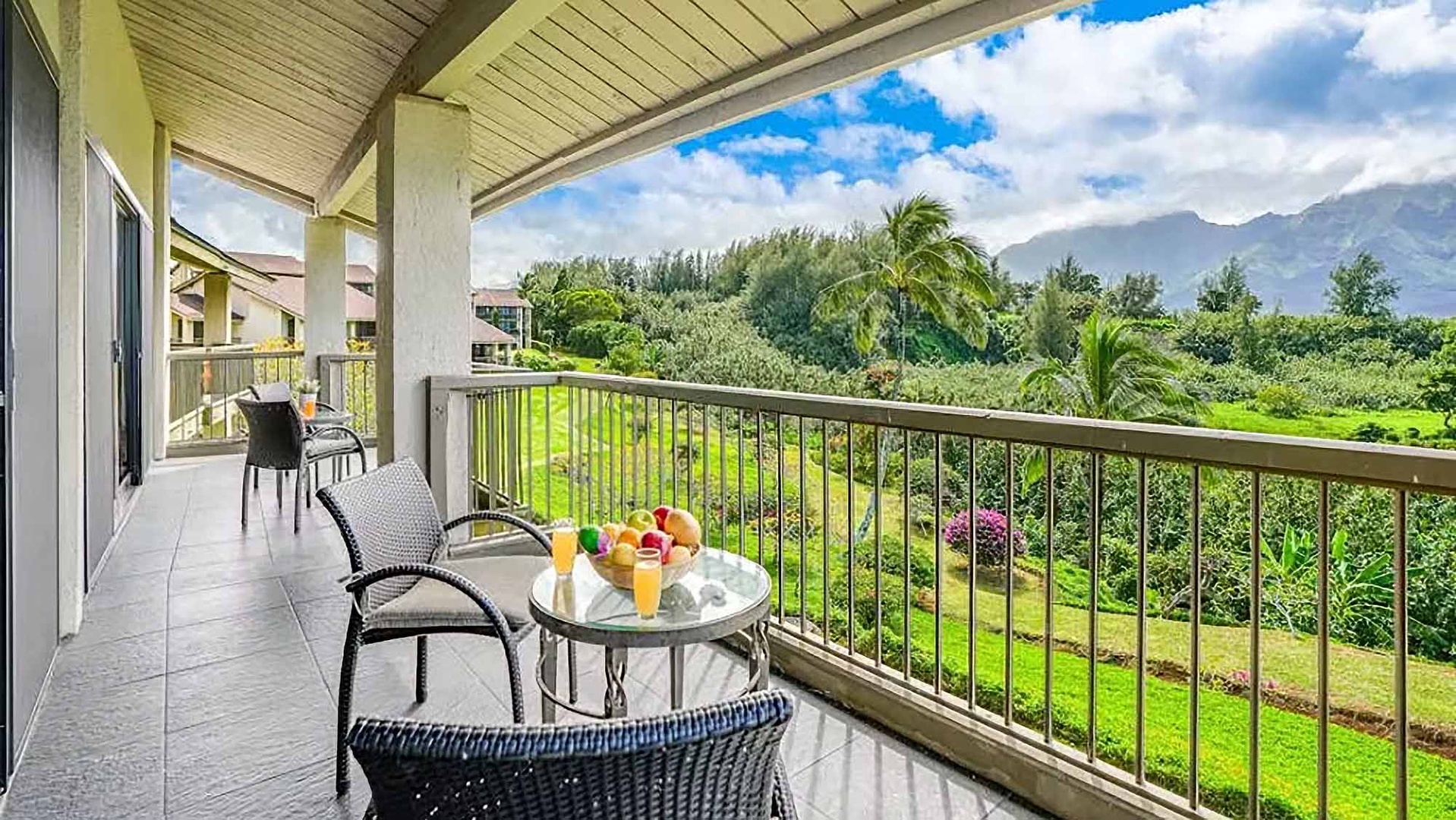 Start your mornings with fresh juice and mountain views from your private balcony, surrounded by lush tropical gardens and distant peaks.