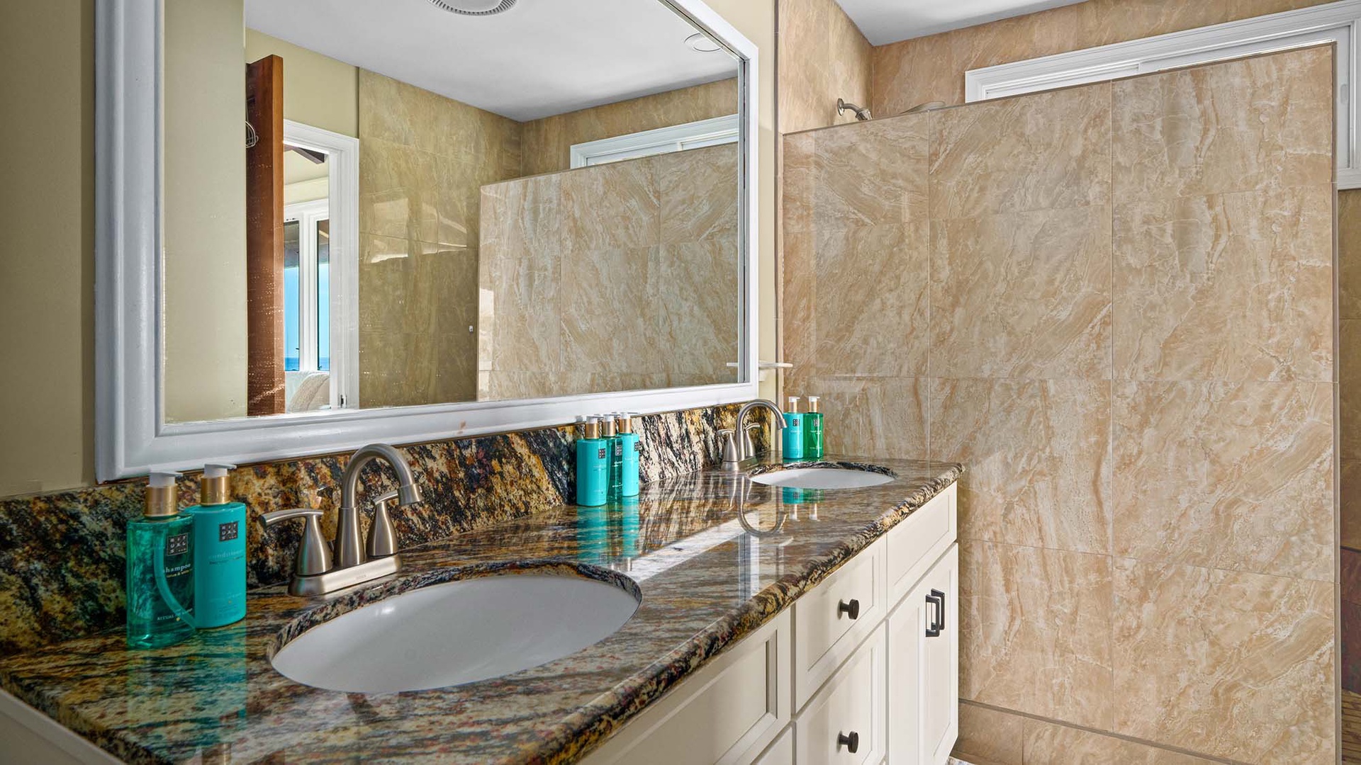 Refresh in your elegant marble bathroom with dual vanities, rainfall shower, and premium toiletries ready for your arrival.