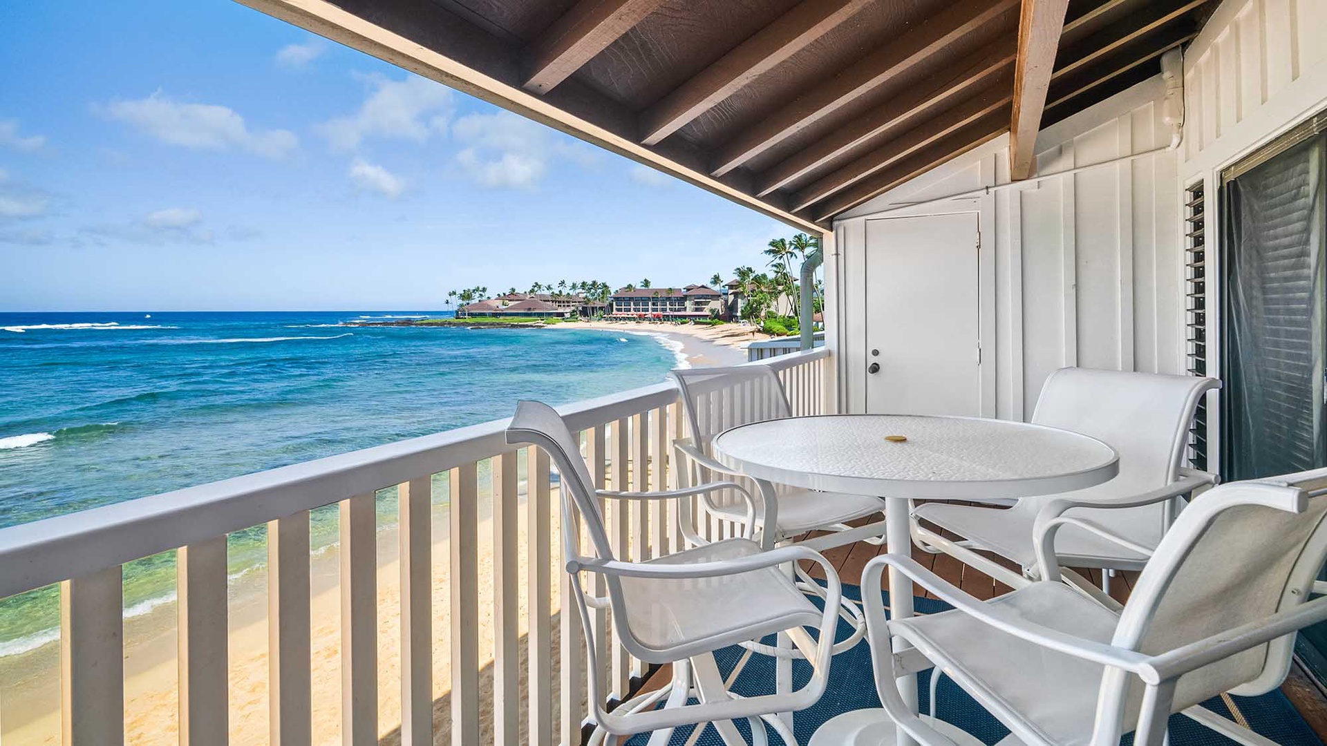 The private lanai features stunning oceanfront views, casual dining space, and gentle tropical breezes. Relax at your waterfront table and watch waves roll in along the sandy shore.