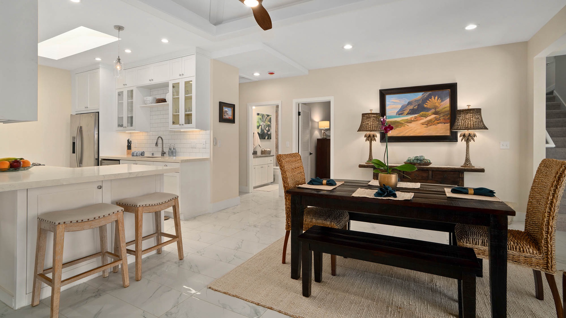 Gather around the welcoming dining table, which flows seamlessly into your bright, modern kitchen—complete with stylish cabinetry, gleaming countertops, and everything you need to whip up your favorite meals or quick snacks.