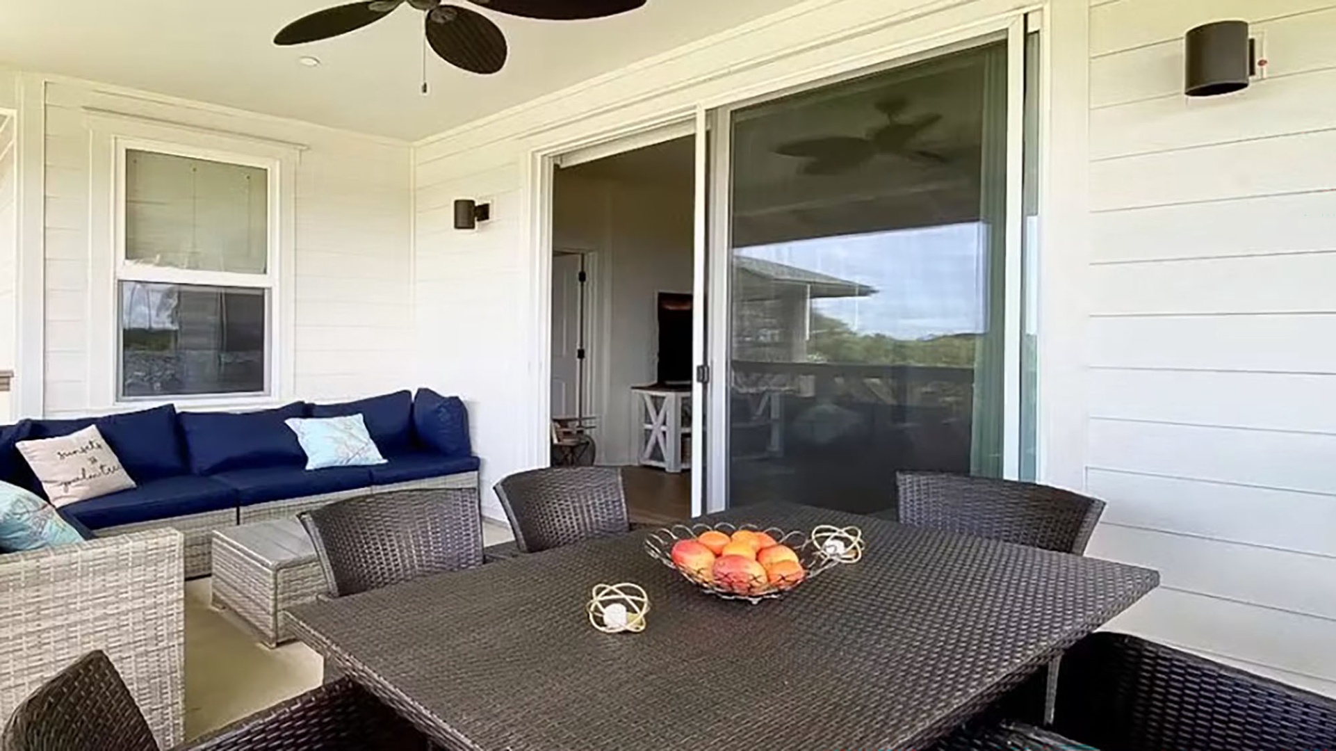 Gather with your loved ones on this charming covered porch, where ceiling fans keep you cool as you dine al fresco with comfy wicker seating and fresh coastal breezes.