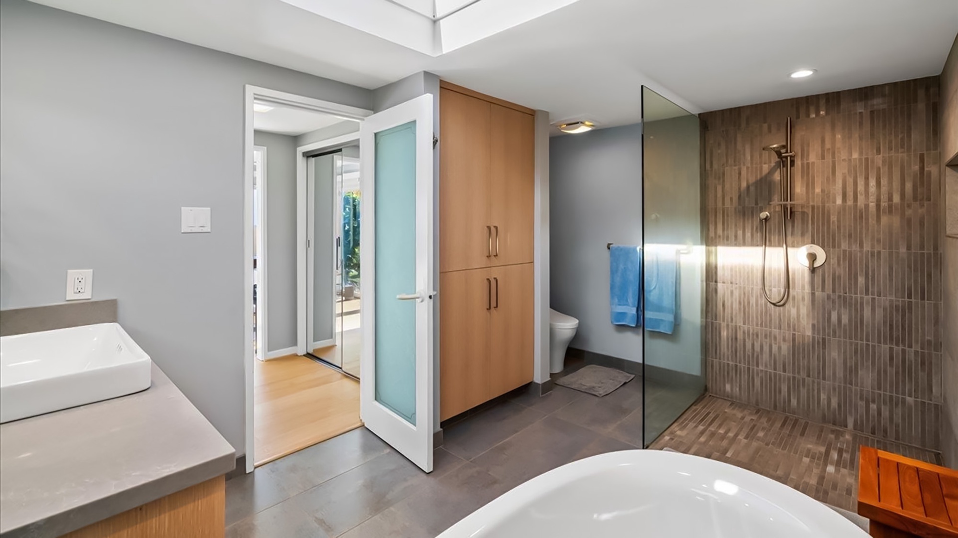 Step into your spa-like ensuite where warm wood tones and sleek glass create the perfect retreat for unwinding after your adventures.