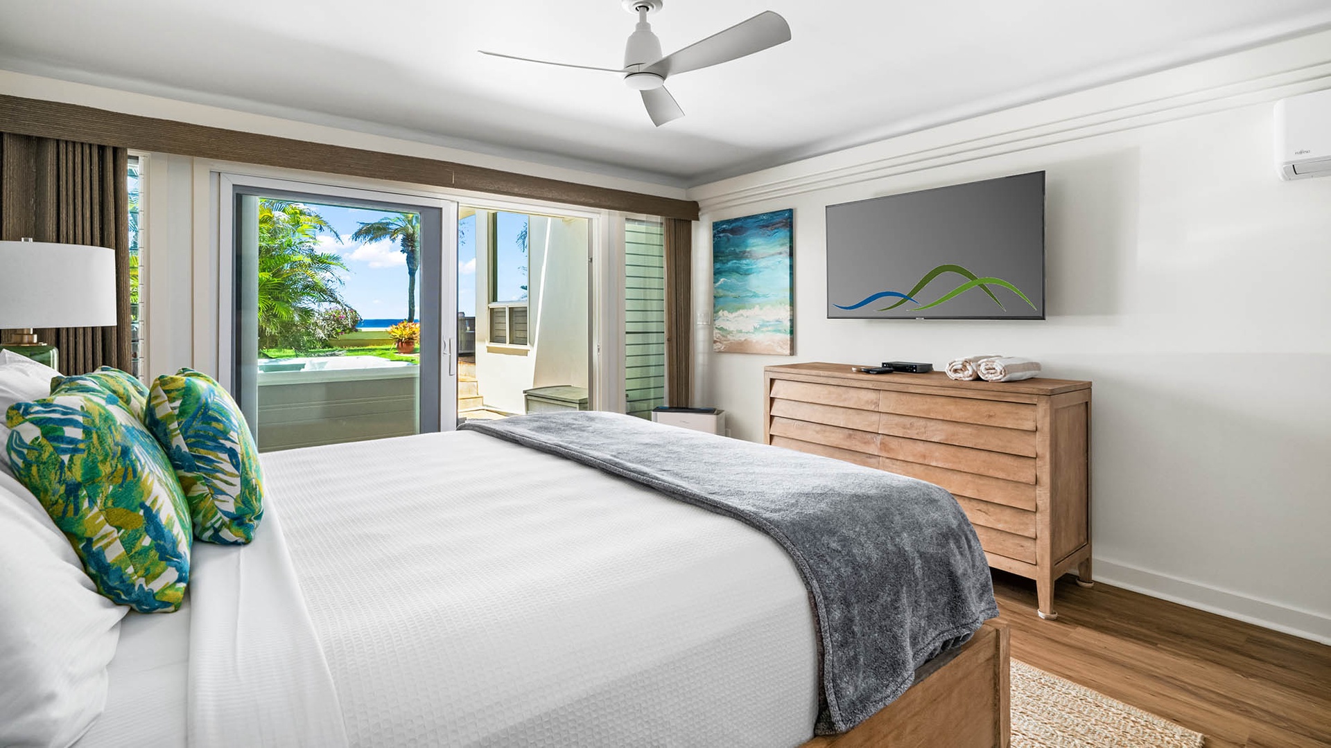 Wake up to tropical breezes and ocean views just beyond your balcony, where crisp linens and coastal artwork create your perfect island retreat.