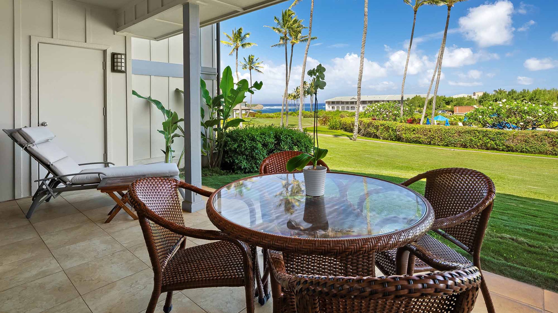 Step onto your private patio where a cozy seating area invites relaxation. Lounge on the sun chair or gather around the glass-top table while enjoying tropical breezes, manicured lawns, swaying palms, and serene ocean views.