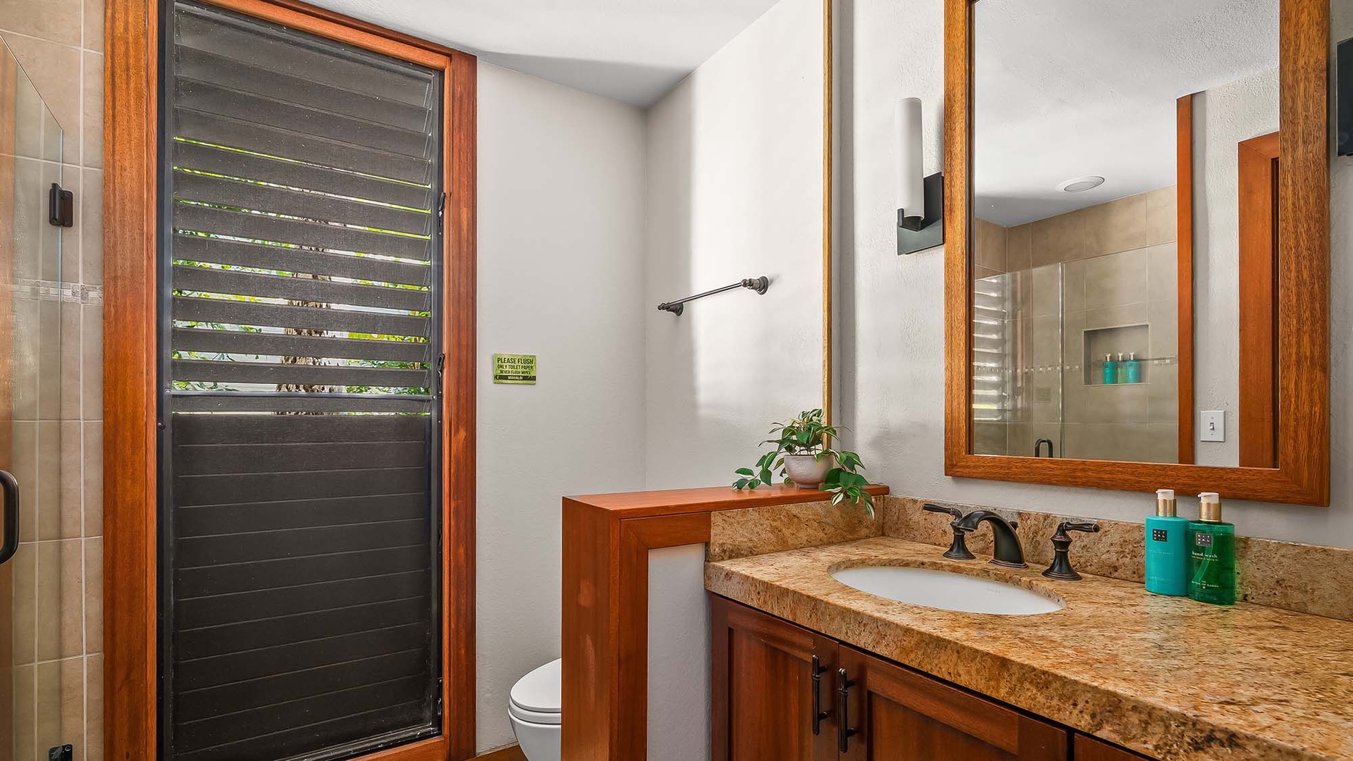 Your private bathroom blends natural wood accents with modern comfort—a serene space to refresh after a day of exploring.