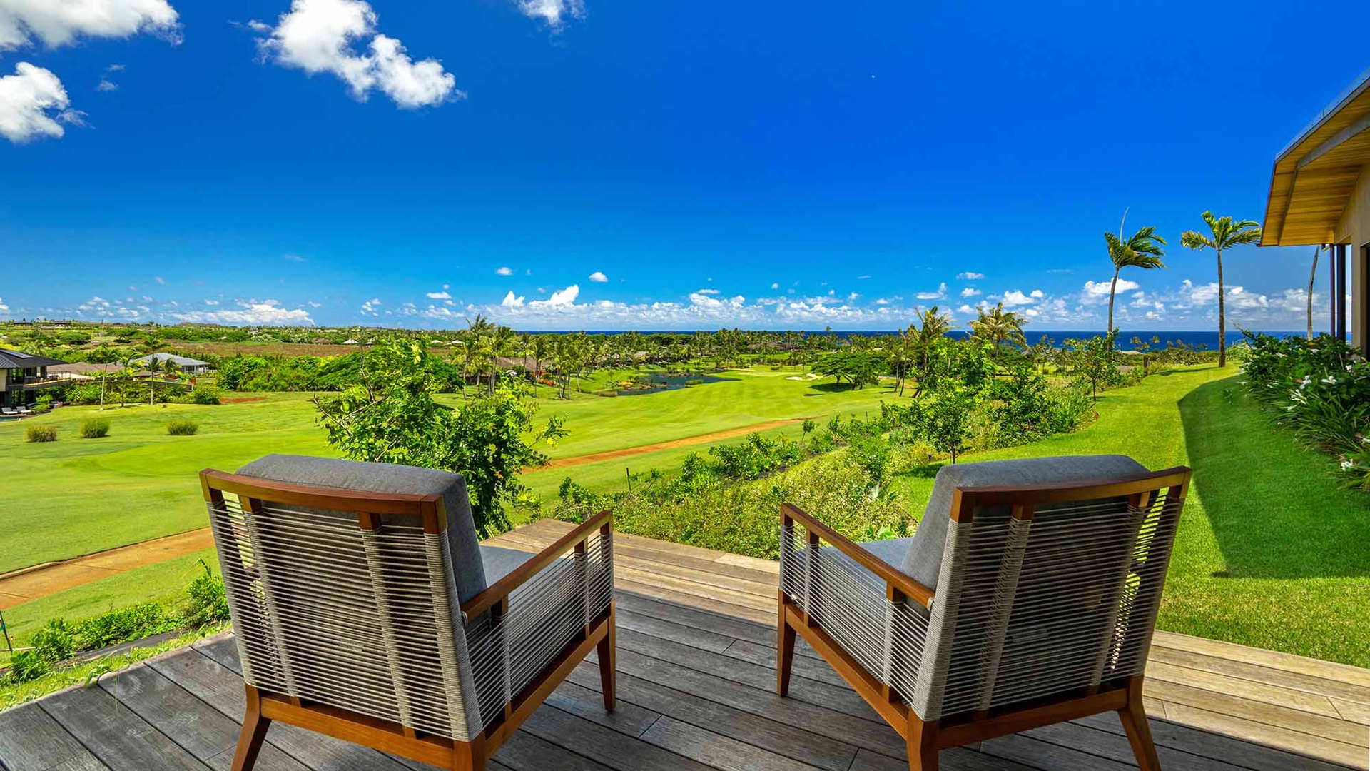 Your private deck overlooks lush fairways, swaying palms, and endless ocean — a perfect spot to unwind and savor the view.