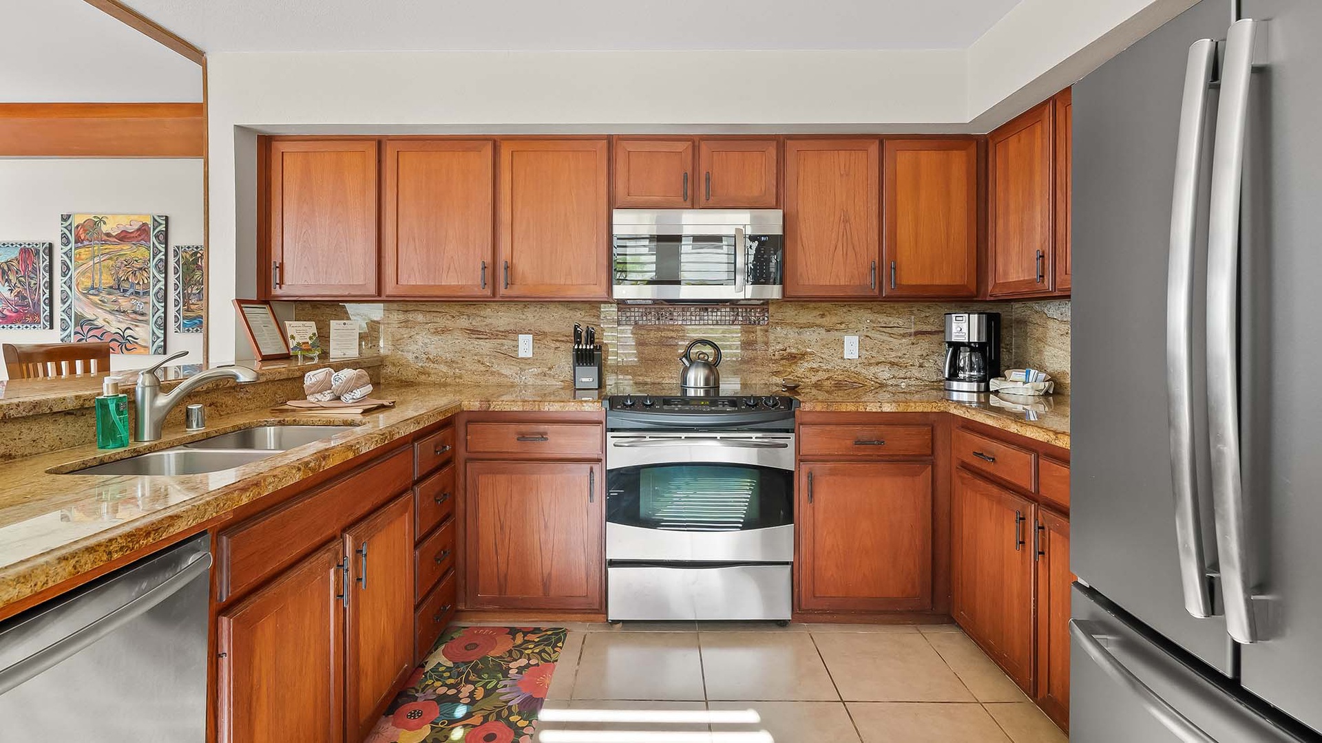 Step into your fully equipped kitchen with warm wood cabinetry, granite counters, and modern appliances ready for cooking and gathering. The cheerful space invites you to prepare meals and start your day with everything you need at your fingertips.