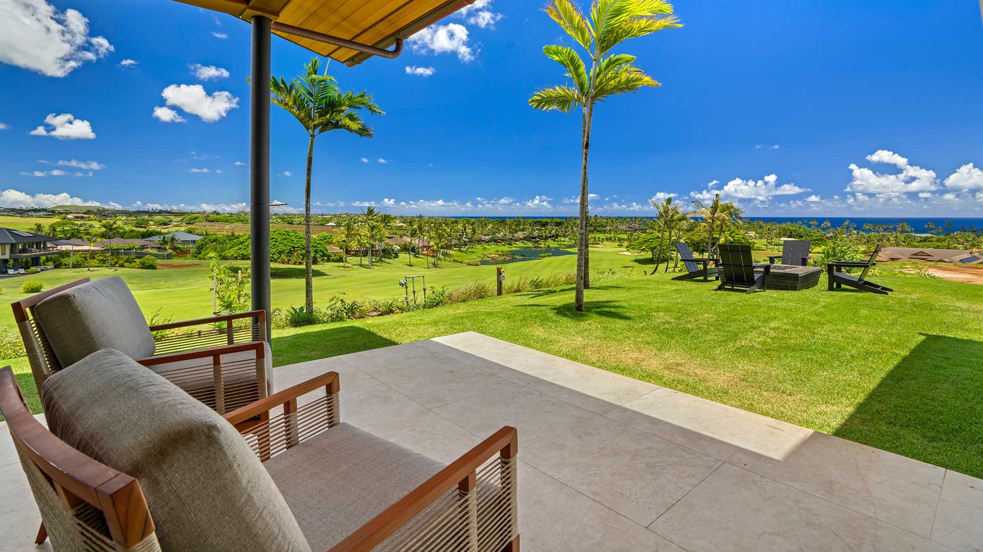 Your private covered patio opens to expansive ocean views, swaying palms, and lush green surroundings—perfect for morning coffee or sunset cocktails in pure Hawaiian serenity.