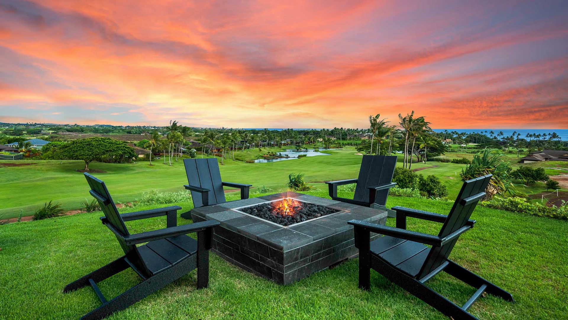 A gathering spot overlooking lush golf course greens and swaying palms, where evening fire meets stunning tropical sunset views.