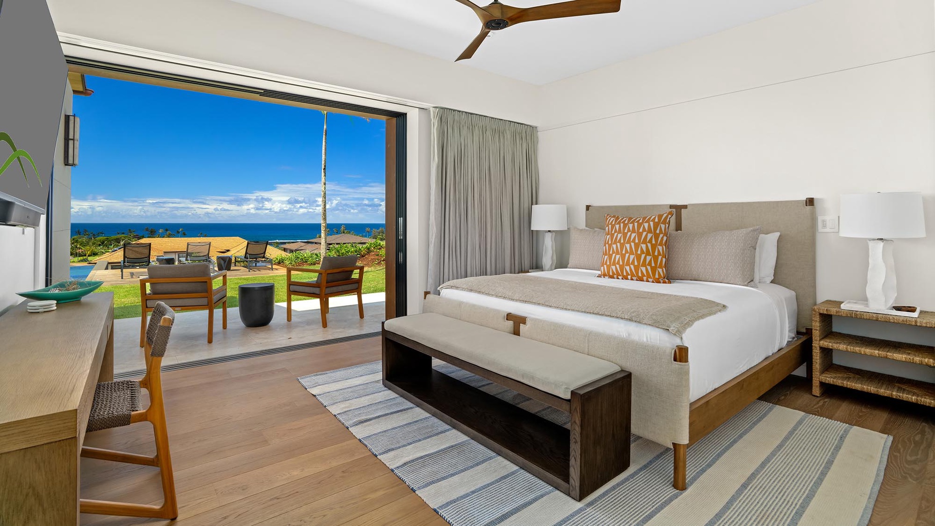 Wake up to endless ocean views from your private lanai. This airy bedroom opens directly to your outdoor space, where you can watch waves roll in and feel the island breeze—pure paradise from the moment you rise.
