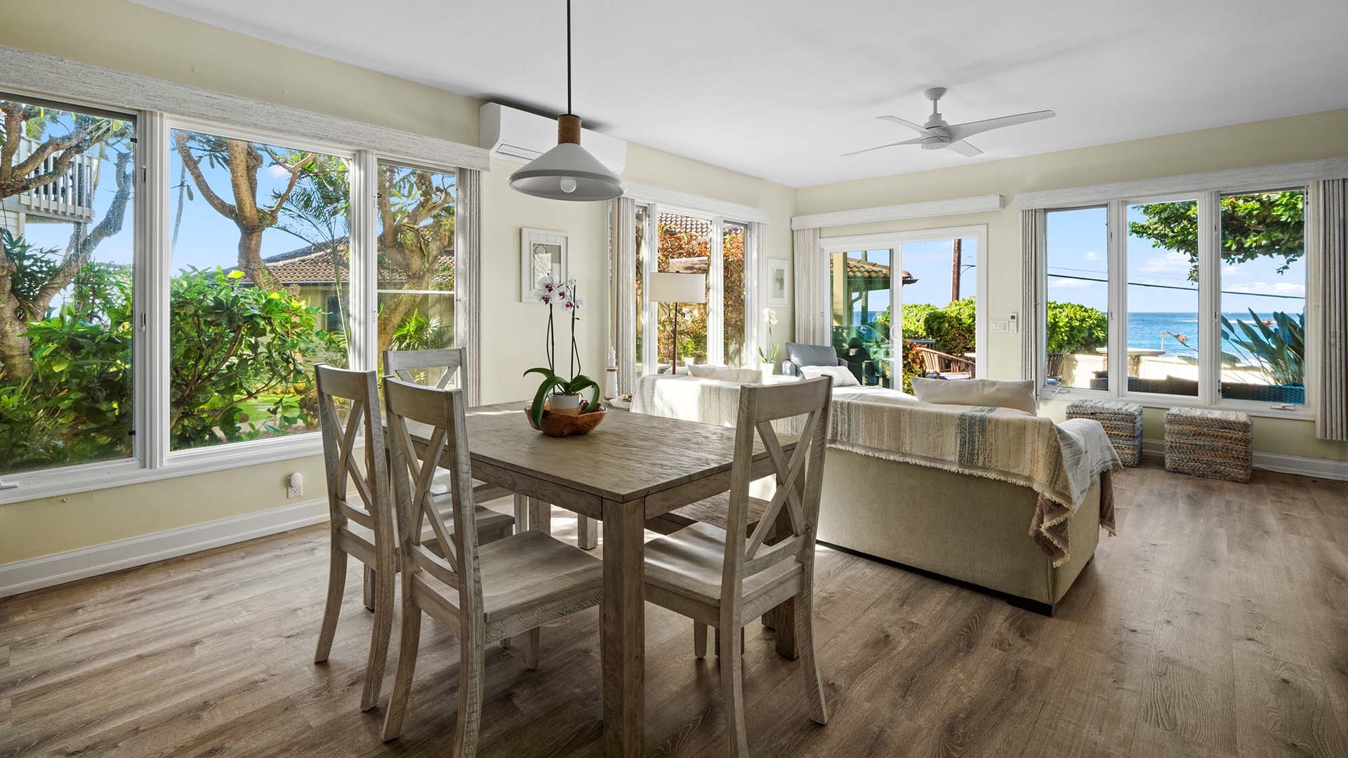Your bright dining space flows seamlessly with ocean views through floor-to-ceiling windows, creating the perfect coastal retreat for memorable meals.