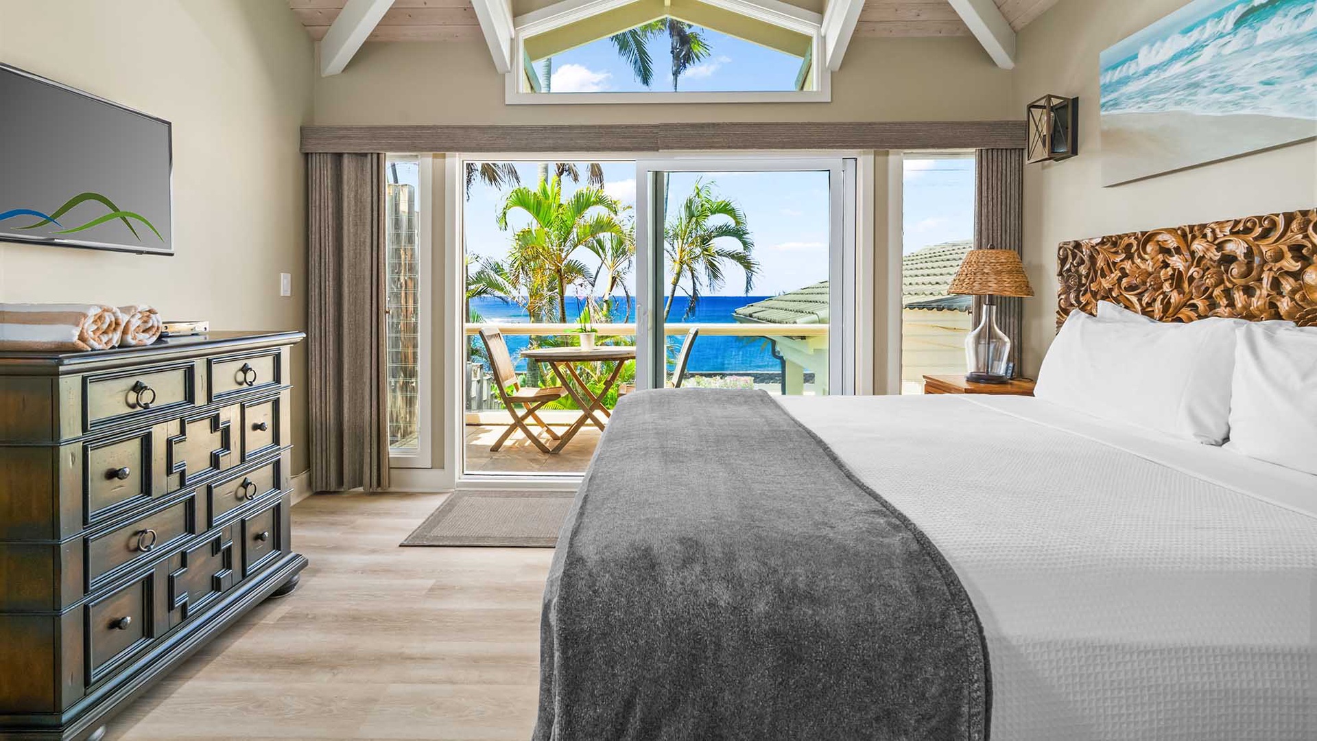 Wake up to stunning ocean views from your bright, breezy bedroom. Step through glass doors to your private terrace, where palm trees sway above a sparkling pool just steps away.