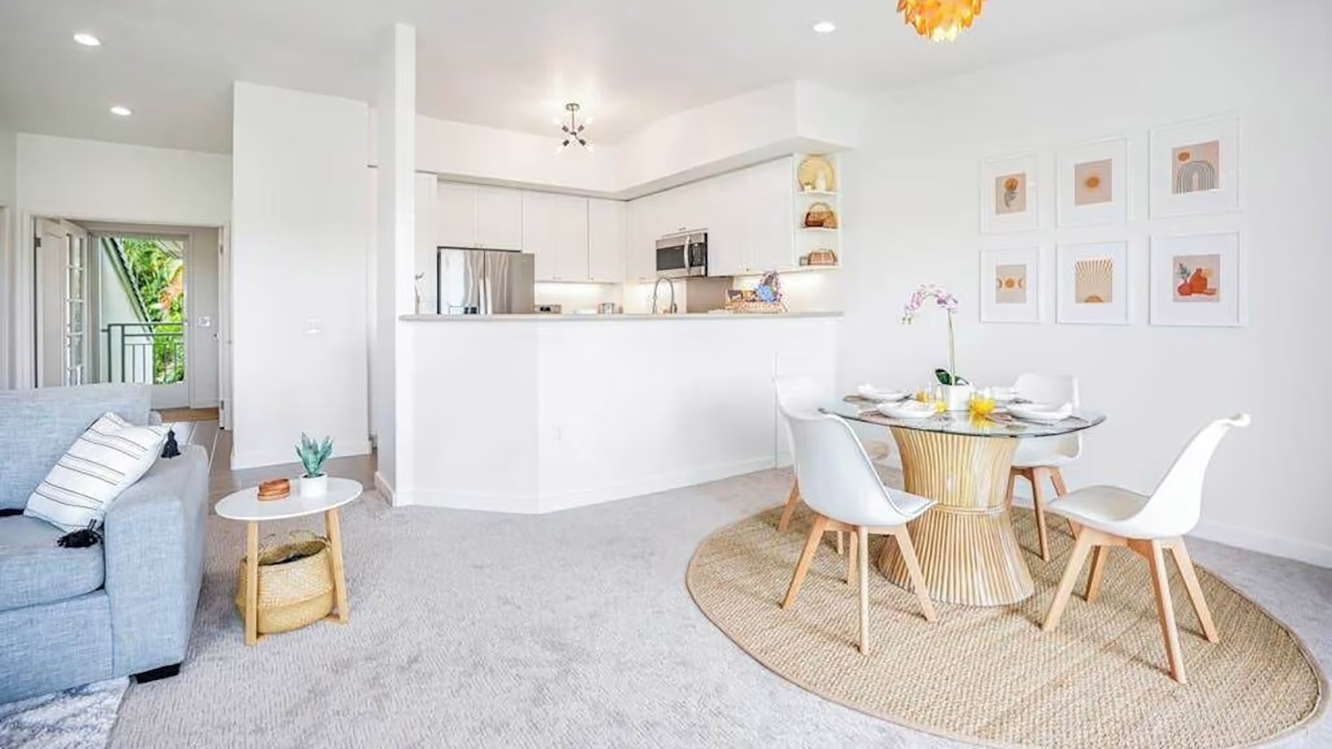 Bright, airy open-concept living with a modern kitchen and inviting dining space flooded with natural light—perfect for morning coffee or gathering with loved ones.