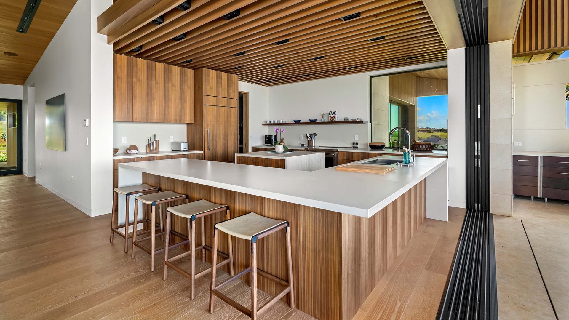 Your dream kitchen awaits, blending sleek design with warm wood tones. Gather at the spacious island, where every meal becomes a moment to savor in this open, light-filled space.