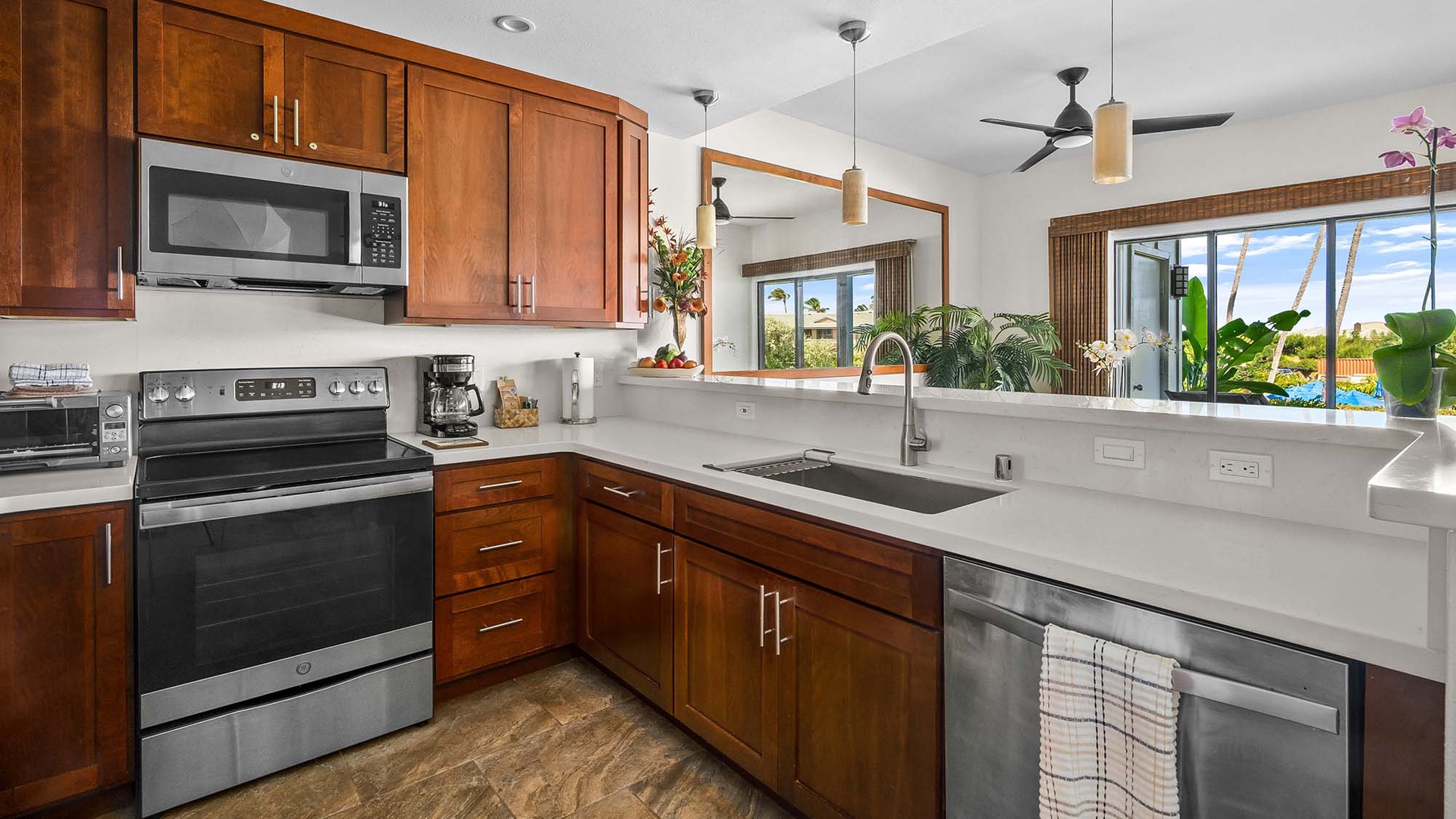 Your fully-equipped kitchen invites you to prepare meals with ease, featuring modern appliances, ample counter space, and tropical garden views that bring the island indoors.