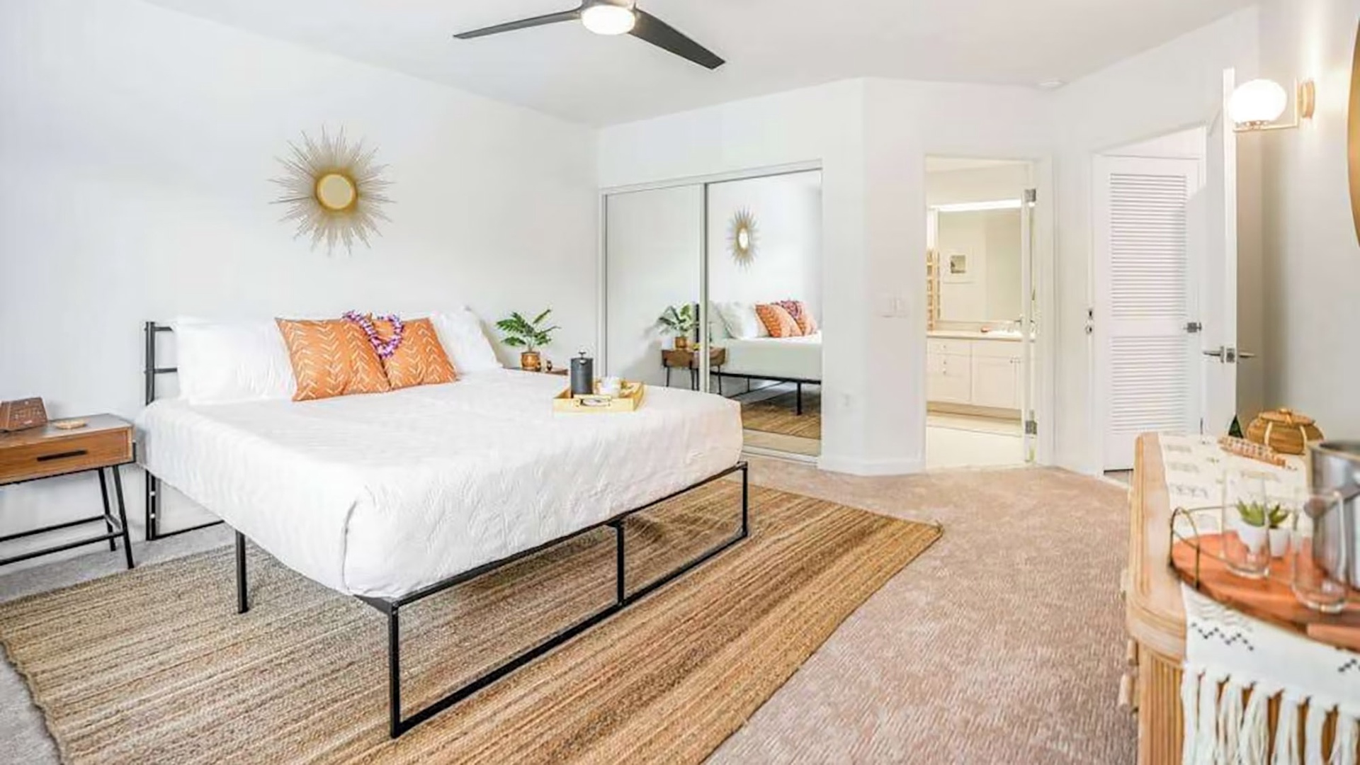 Step into your serene retreat—a sunlit bedroom with crisp white linens, warm accents, and thoughtful touches that make unwinding effortless. Your private oasis awaits.