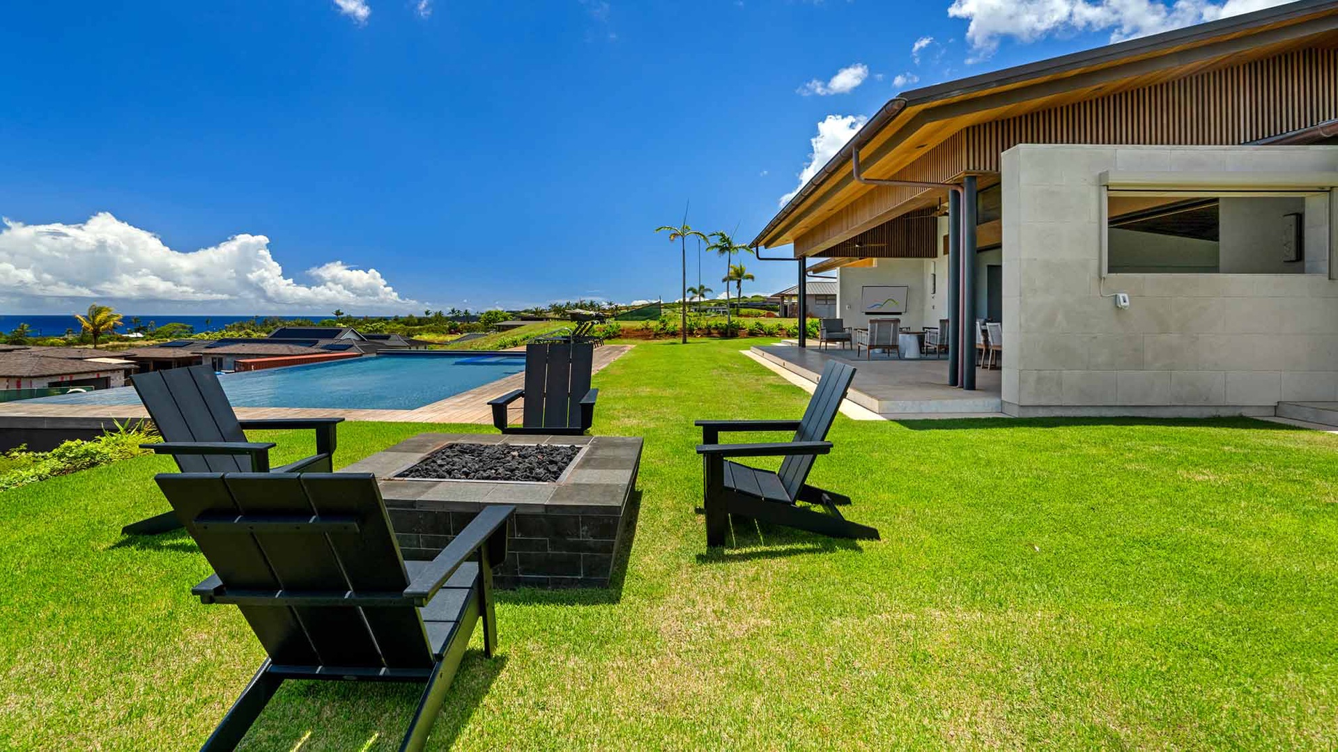 Gather around the fire pit on the lush lawn, with ocean breezes and sparkling pool views wrapping around you—your perfect spot for sunset conversations and s'mores.
