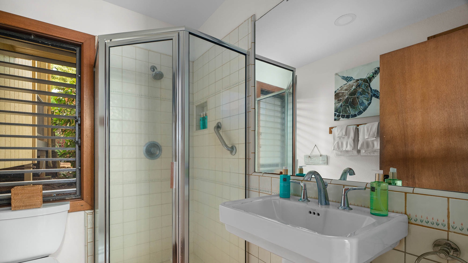 Unwind in your spa-like bathroom featuring a refreshing shower and coastal-inspired décor that brings beach vibes indoors.