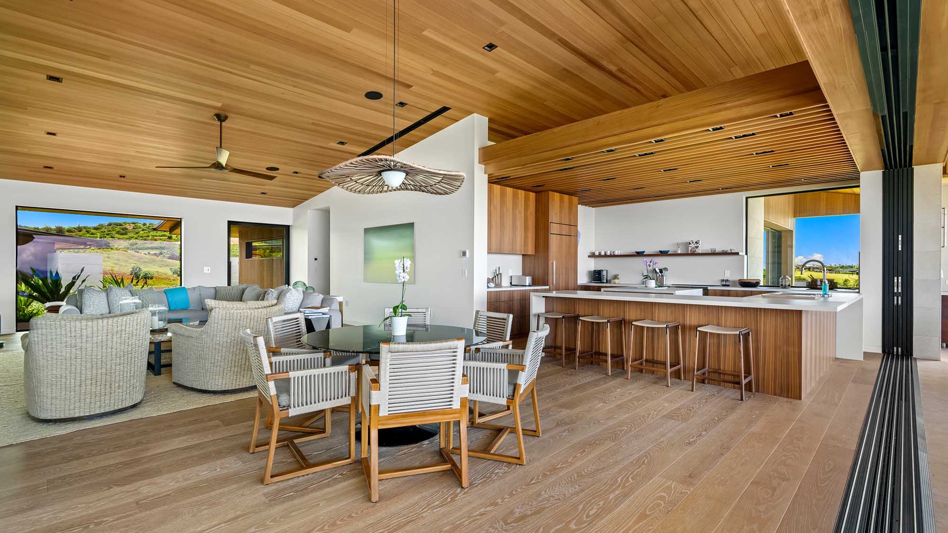 Step into your open-concept haven where modern island living meets luxury. The stunning wood ceiling and sleek kitchen island invite you to gather, cook, and create unforgettable memories in this beautifully designed space.