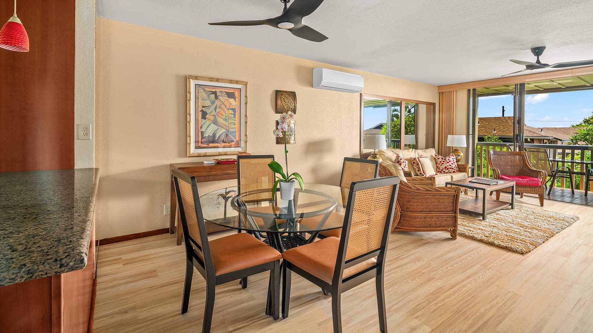 Relax in your open, sun-filled living space where tropical breezes drift through sliding doors to your private balcony. Enjoy meals at the inviting dining table, unwind on plush seating, and savor island charm with every detail.