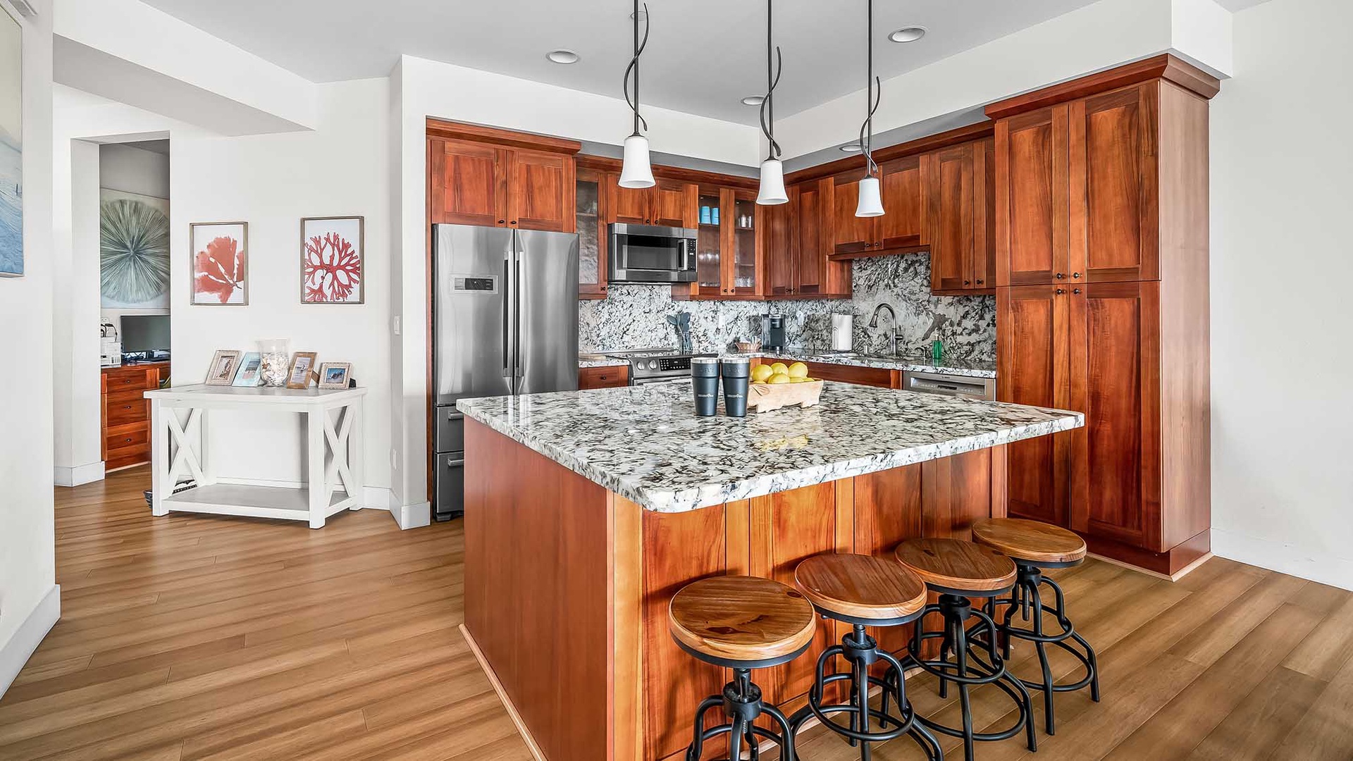 Your vacation home's gourmet kitchen awaits with gleaming granite countertops, warm wood cabinetry, and modern stainless appliances—perfect for cooking memorable meals together.