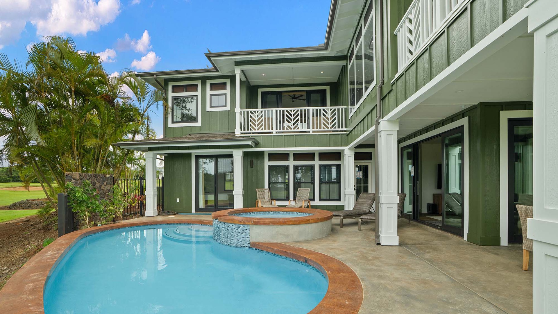 Tropical paradise awaits with your private pool and spa, surrounded by swaying palms under blue skies.