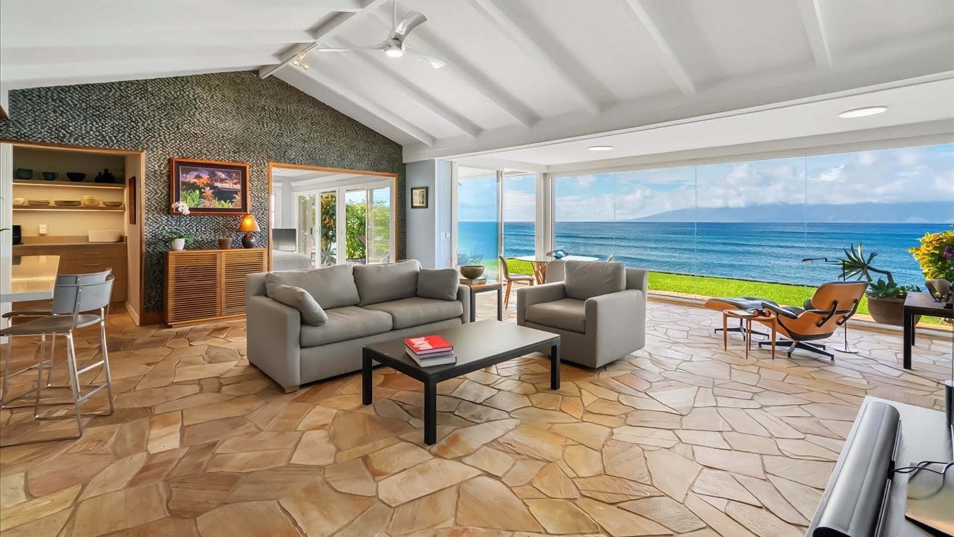 Wake up to breathtaking ocean views from your spacious living room, where floor-to-ceiling windows frame endless blue horizons.