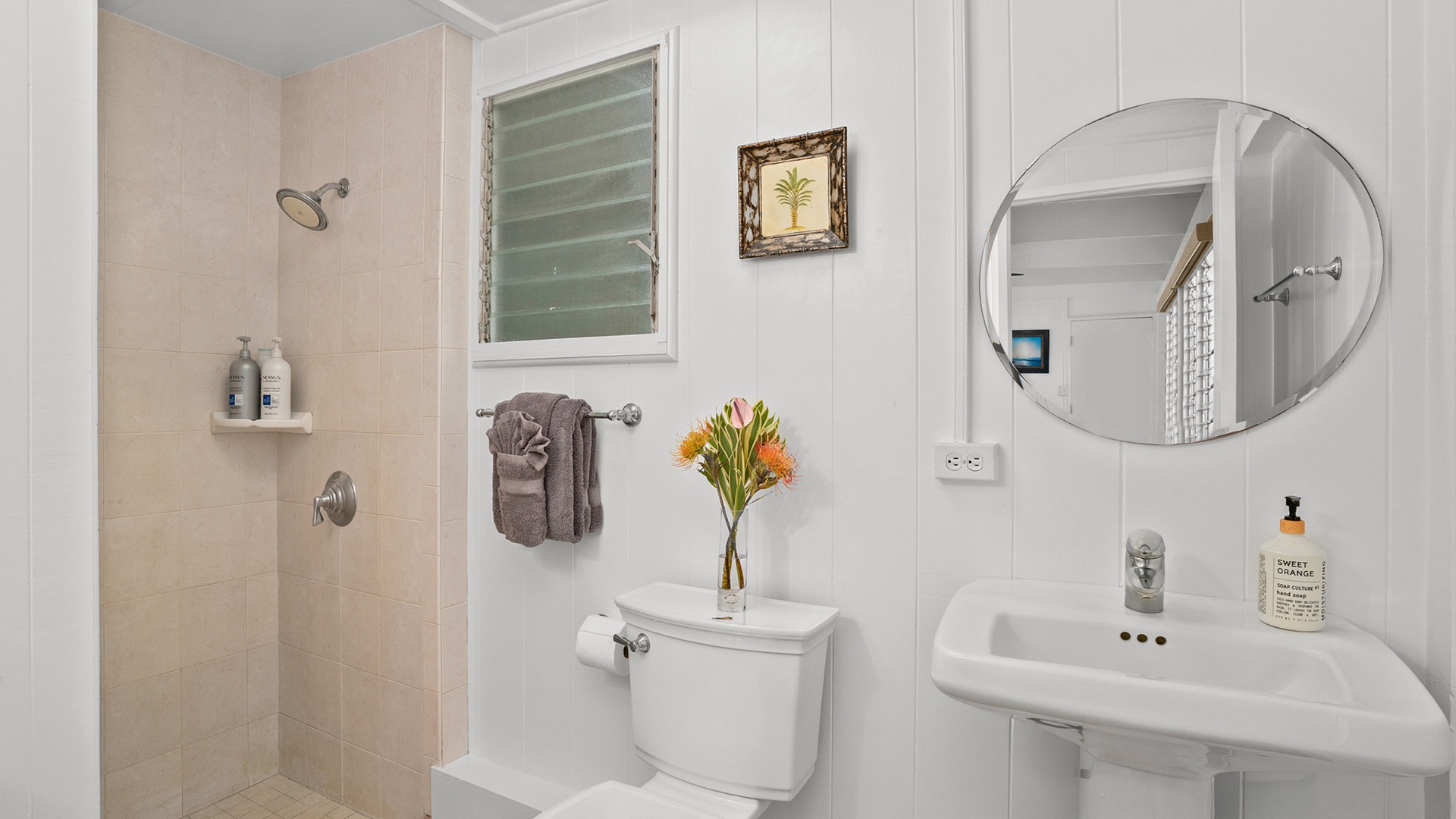 Step into your bright, spotless bathroom with walk-in shower, fresh towels, and thoughtful amenities ready for your comfort.