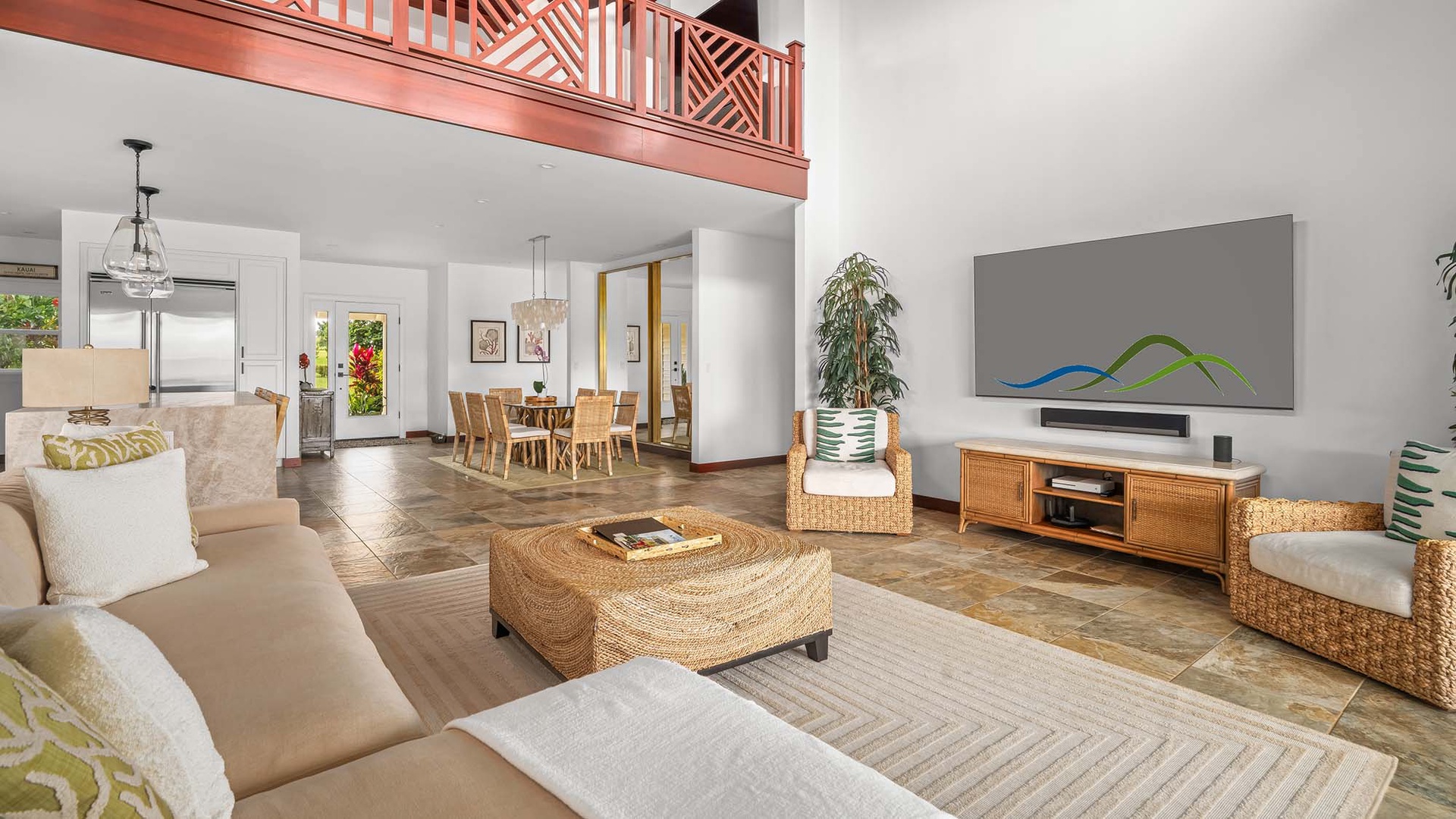 Relax in this bright, open living space with soaring ceilings and lofted details, where woven textures and tropical charm invite you to unwind in style.