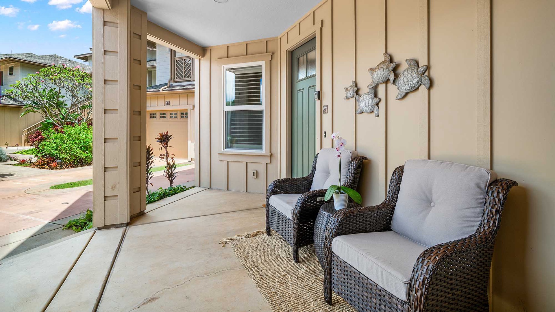 Unwind on your private patio with comfortable seating and charming sea turtle decor, perfect for morning coffee or evening relaxation.